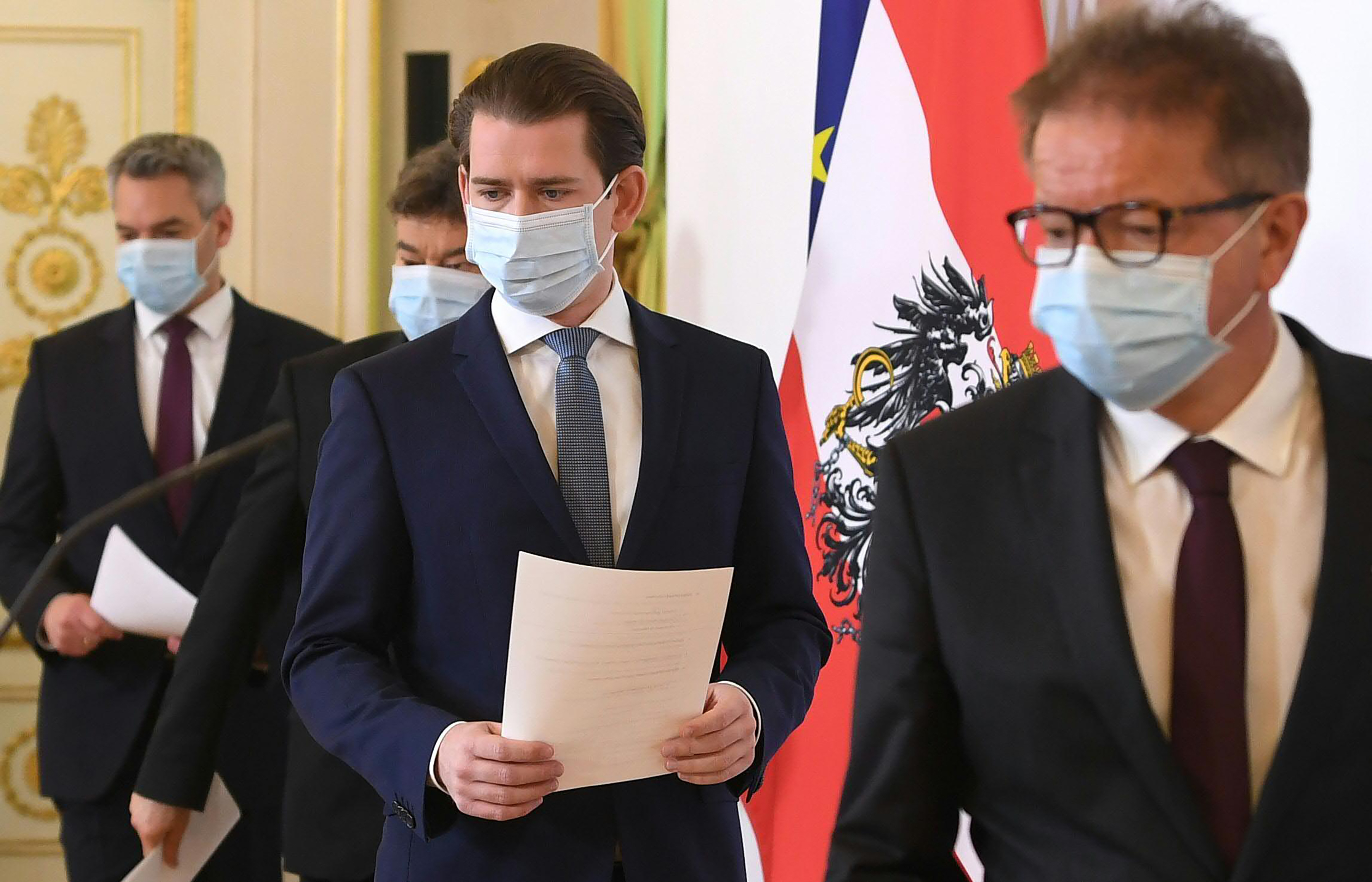 Austrian Chancellor Sebastian Kurz, center, arrives for a news conference about the coronavirus outbreak in Vienna, Austria, on April 6.