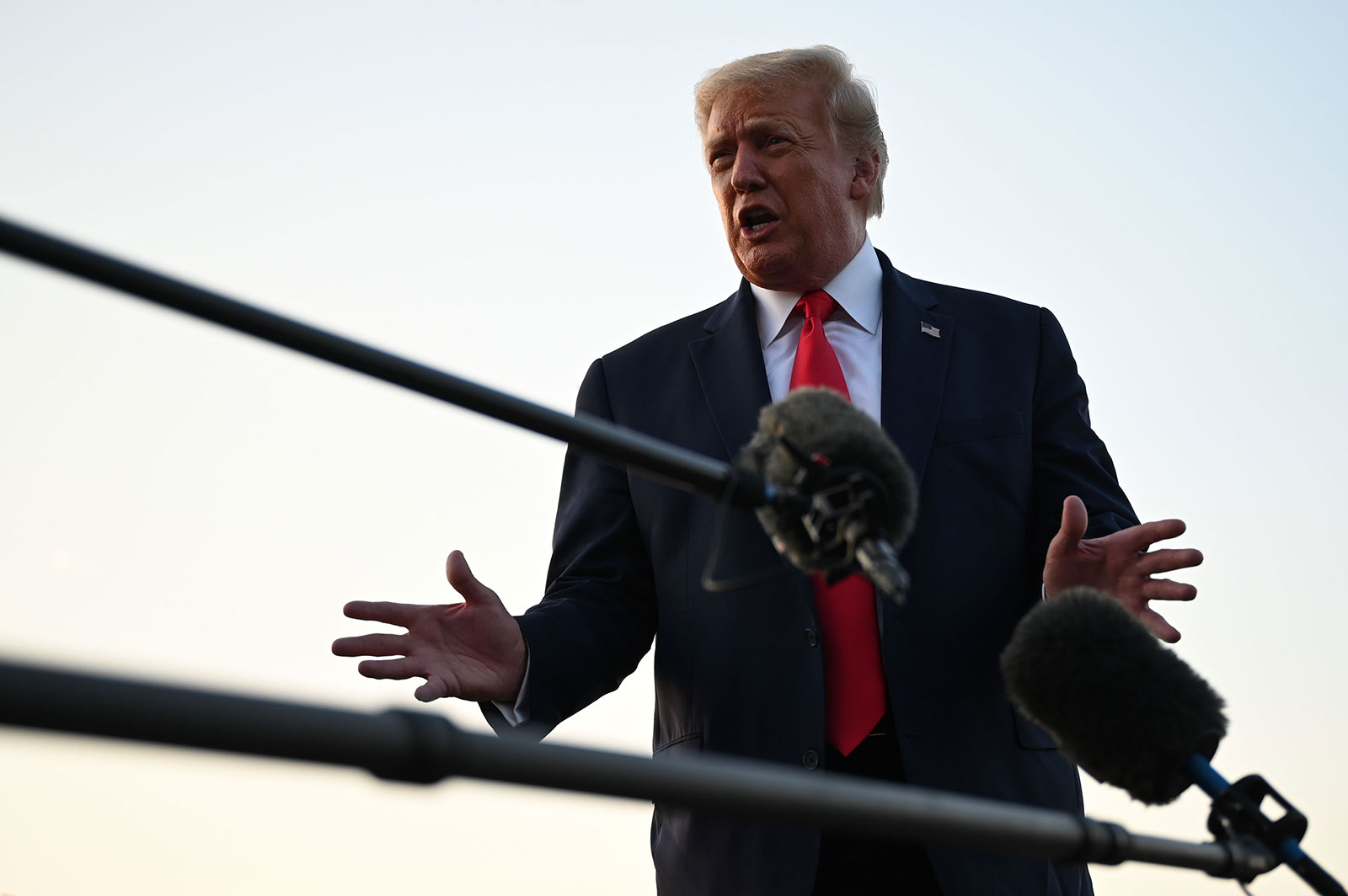 President Trump answers questions from reporters at Morristown Municipal Airport on August 9.