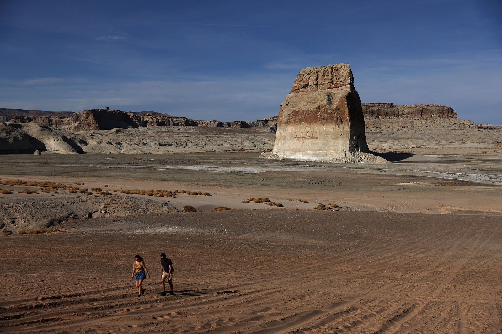 People walk along an area of Lake Powell that used to be underwater in March 2022.
