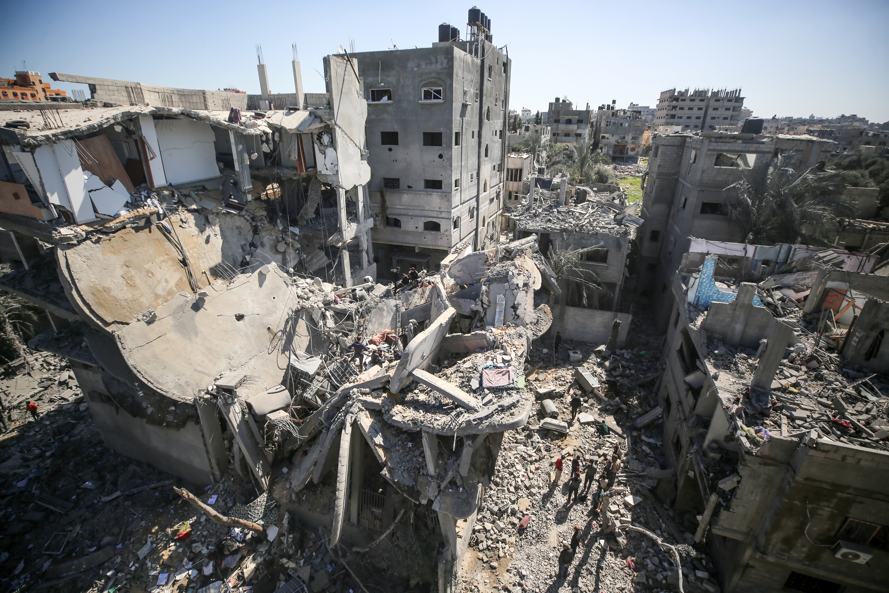 People inspect the damage of a home in Deir al-Balah, Gaza, on March 5.