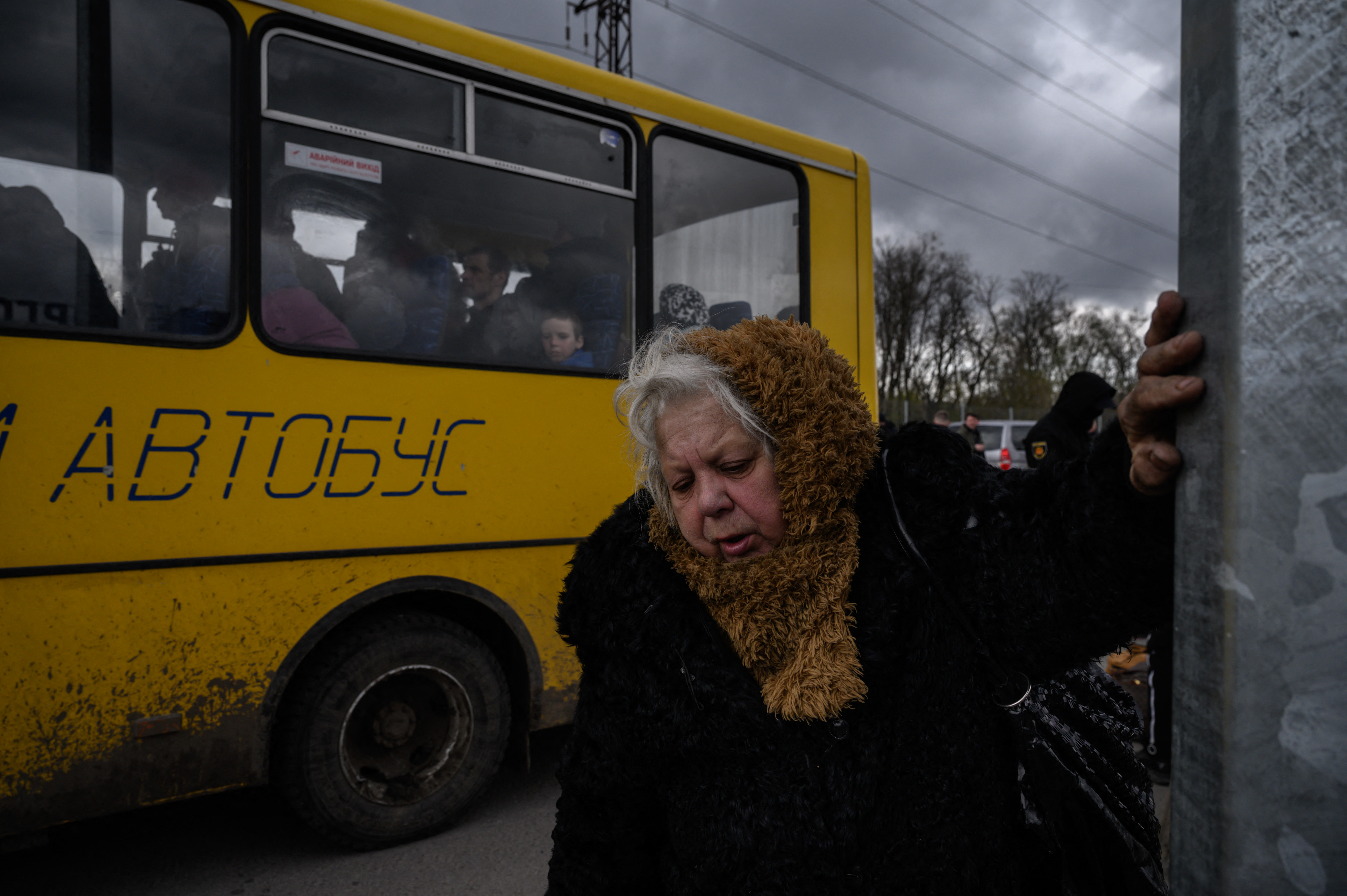 People fleeing fighting in the southern city of Mariupol meet with relatives and friends as they arrive in a small convoy after the opening of a humanitarian corridor, at a registration center for internally displaced people in Zaporizhzhia on April 21.