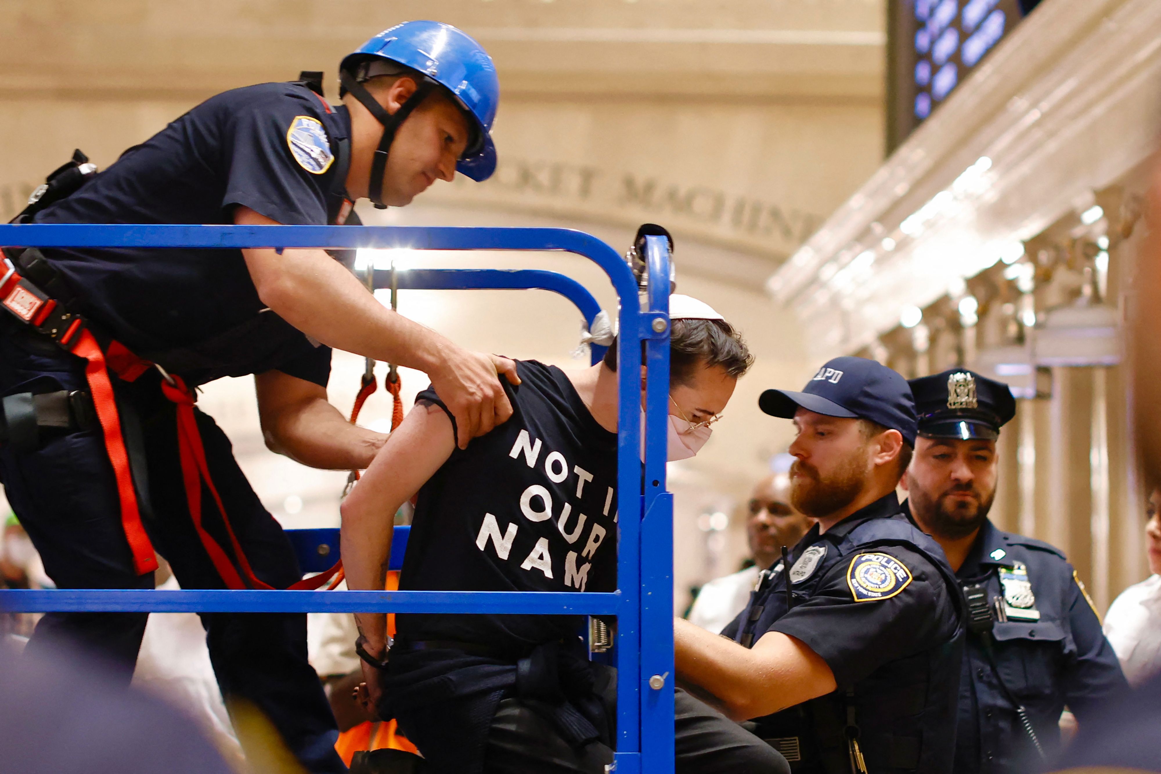NYPD officers arrest a protester during a demonstration calling for a cease-fire amid war between Israel and Hamas, at Grand Central Station in New York City, on October 27.
