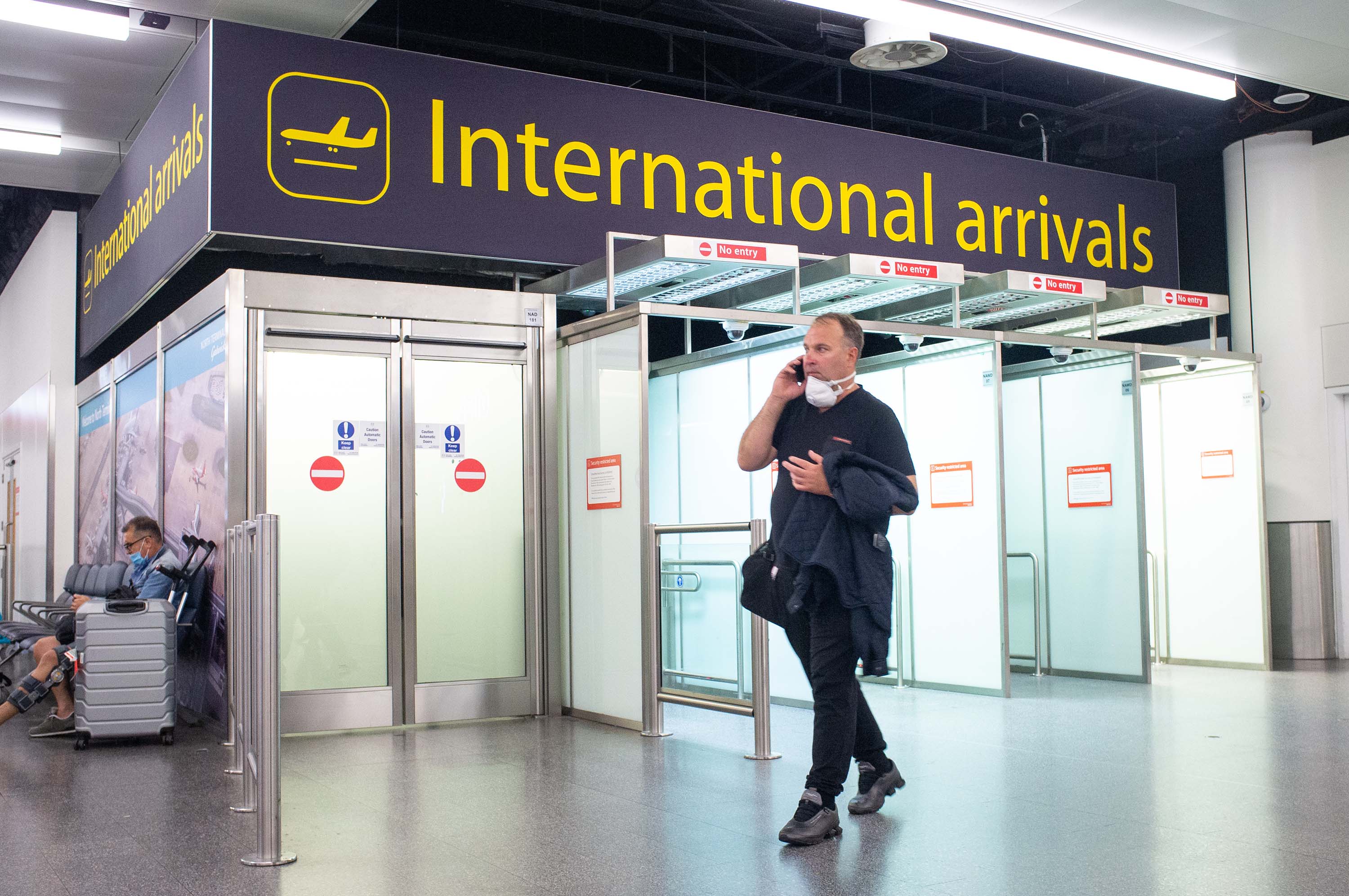 A passenger arrives at Gatwick Airport in Crawley, England, on Saturday, July 25.