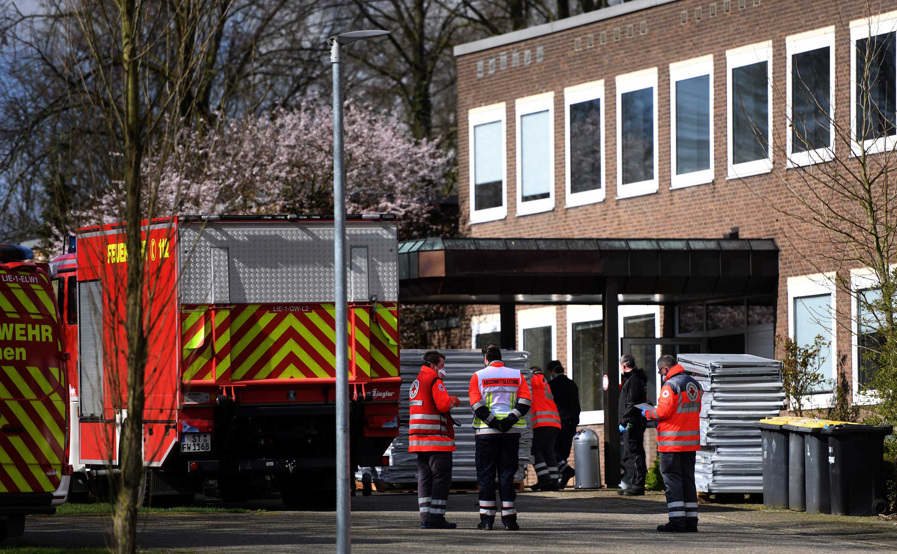 Volunteers transport beds into the former St. Marien hospital in Laer, Germany, on March 21, as the hospital prepares to treat coronavirus patients.
