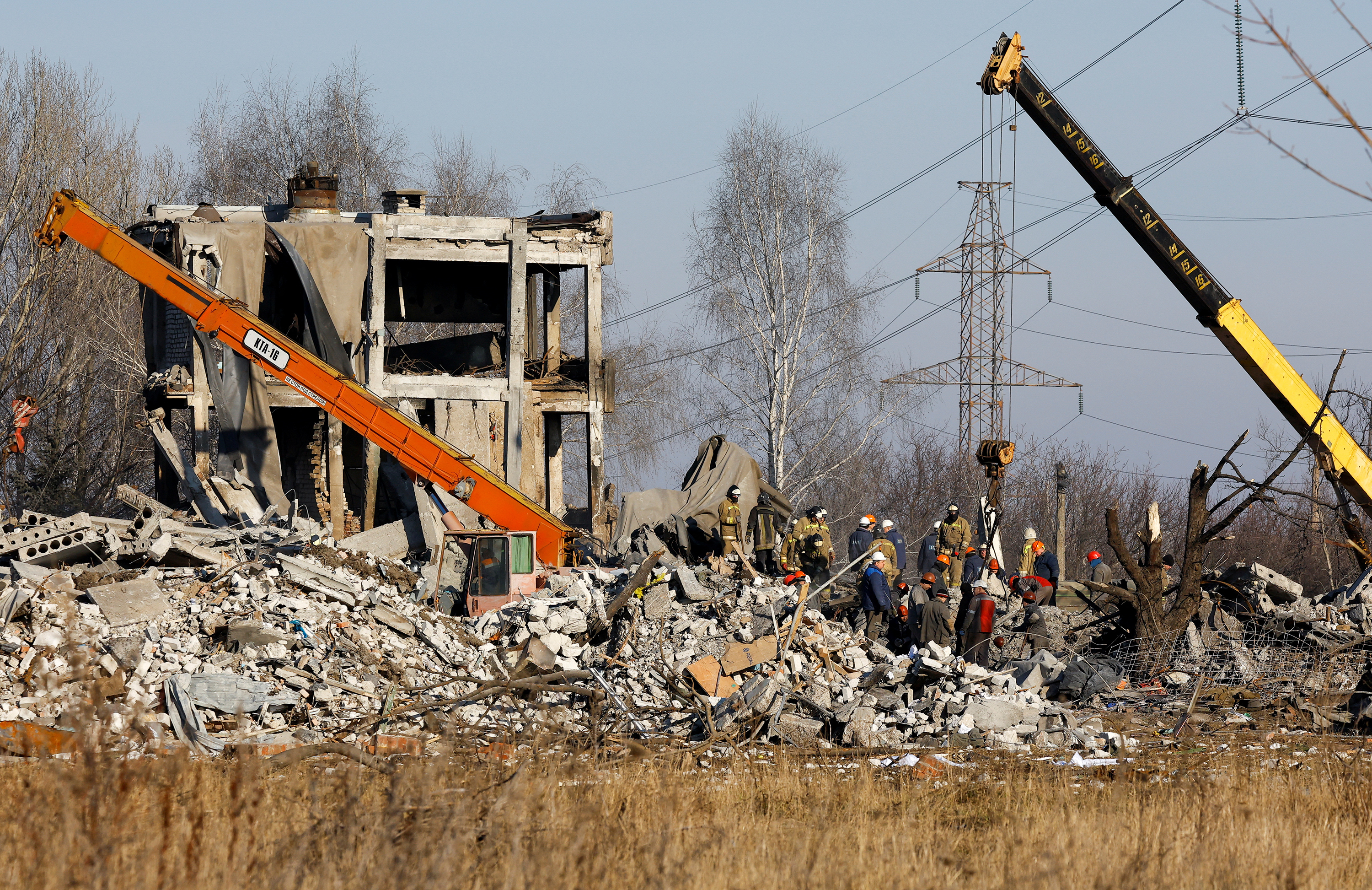 Workers and emergencies' ministry members remove debris of a destroyed building purported to be a vocational college used as temporary accommodation for Russian soldiers. 89 servicemen were killed in the strike in Makiivka on January 3 as stated by the Russian Defense Ministry.