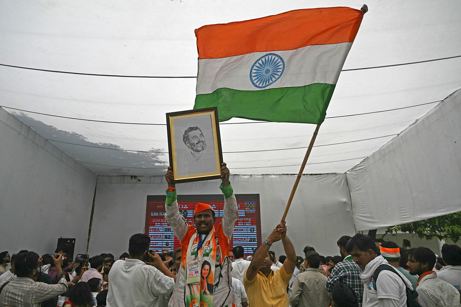A supporter of Indian National Congress (INC) party waves a national flag at the INC headquarter in New Delhi on June 4.