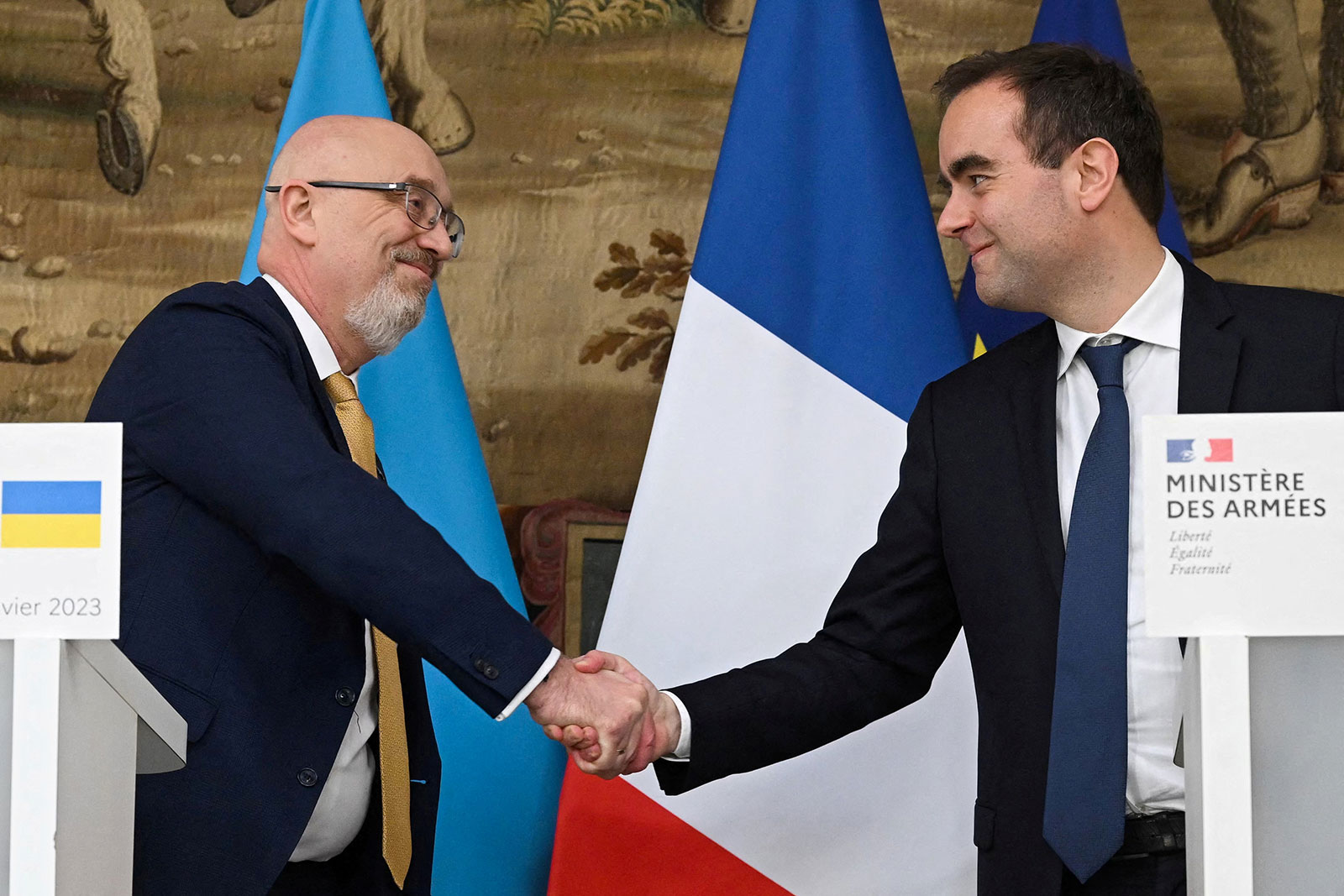 Ukrainian Defense Minister Oleksii Reznikov shakes hands with French Minister of the Armed Forces Sébastien Lecornu during a press conference in Paris on January 31. 
