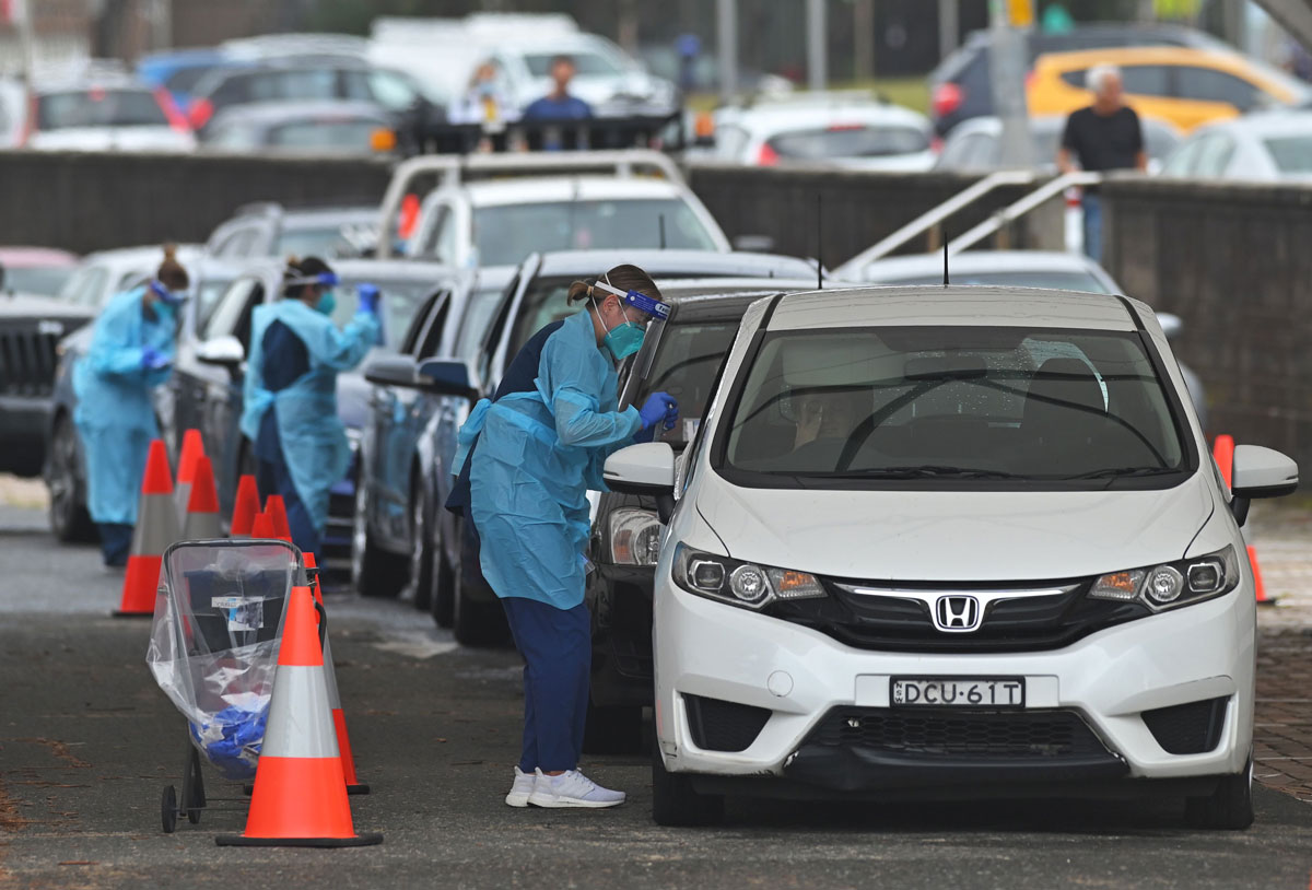 Health workers perform Covid-19 tests at a Bondi Beach drive-through testing centre in Sydney, Australia on December 20.