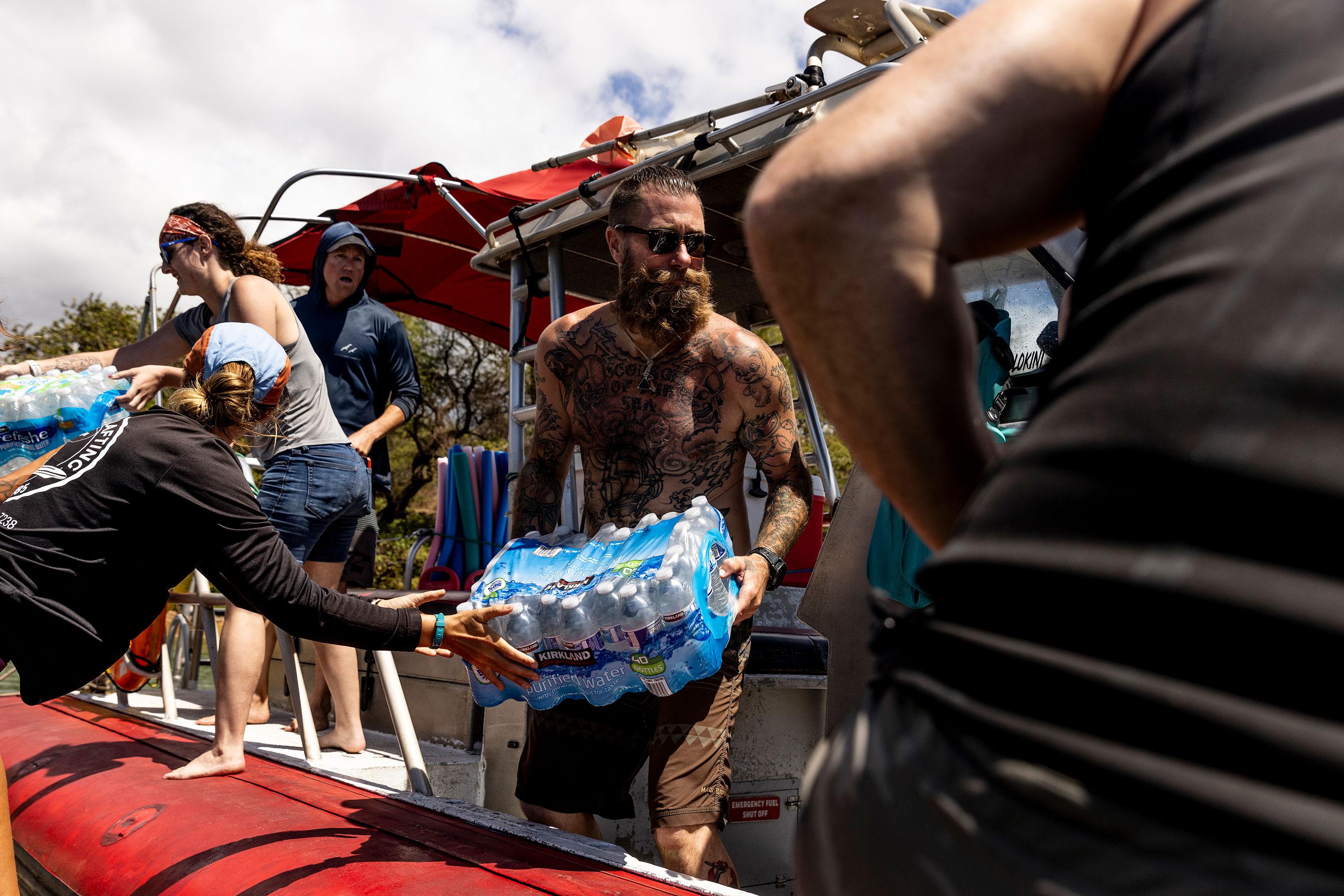Volunteers load supplies in Kihei onto a boat heading to West Maui on Saturday.
