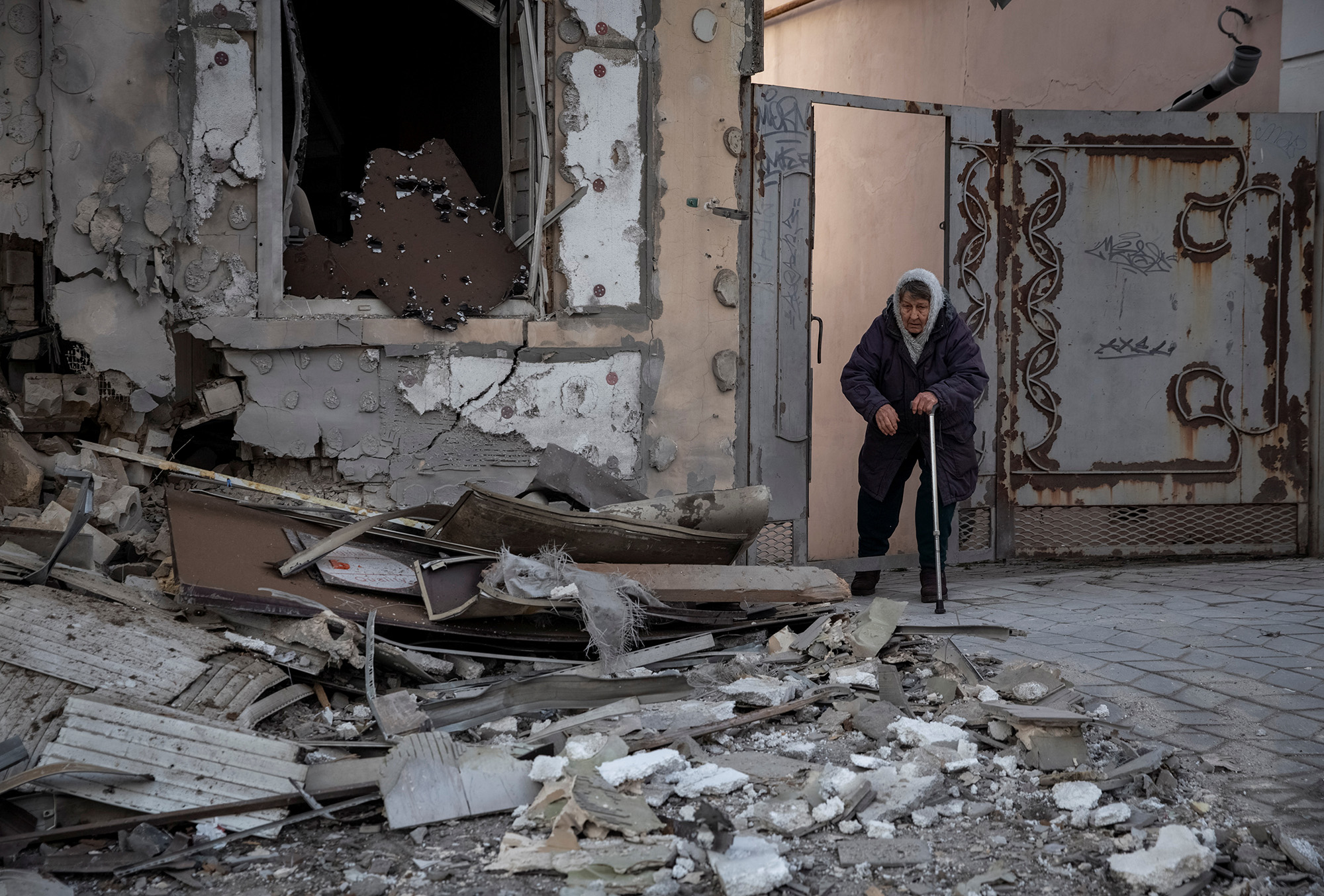 Local resident Klavdia, 82, stands near her house which was destroyed by a Russian military strike in Kherson, Ukraine, on December 29.