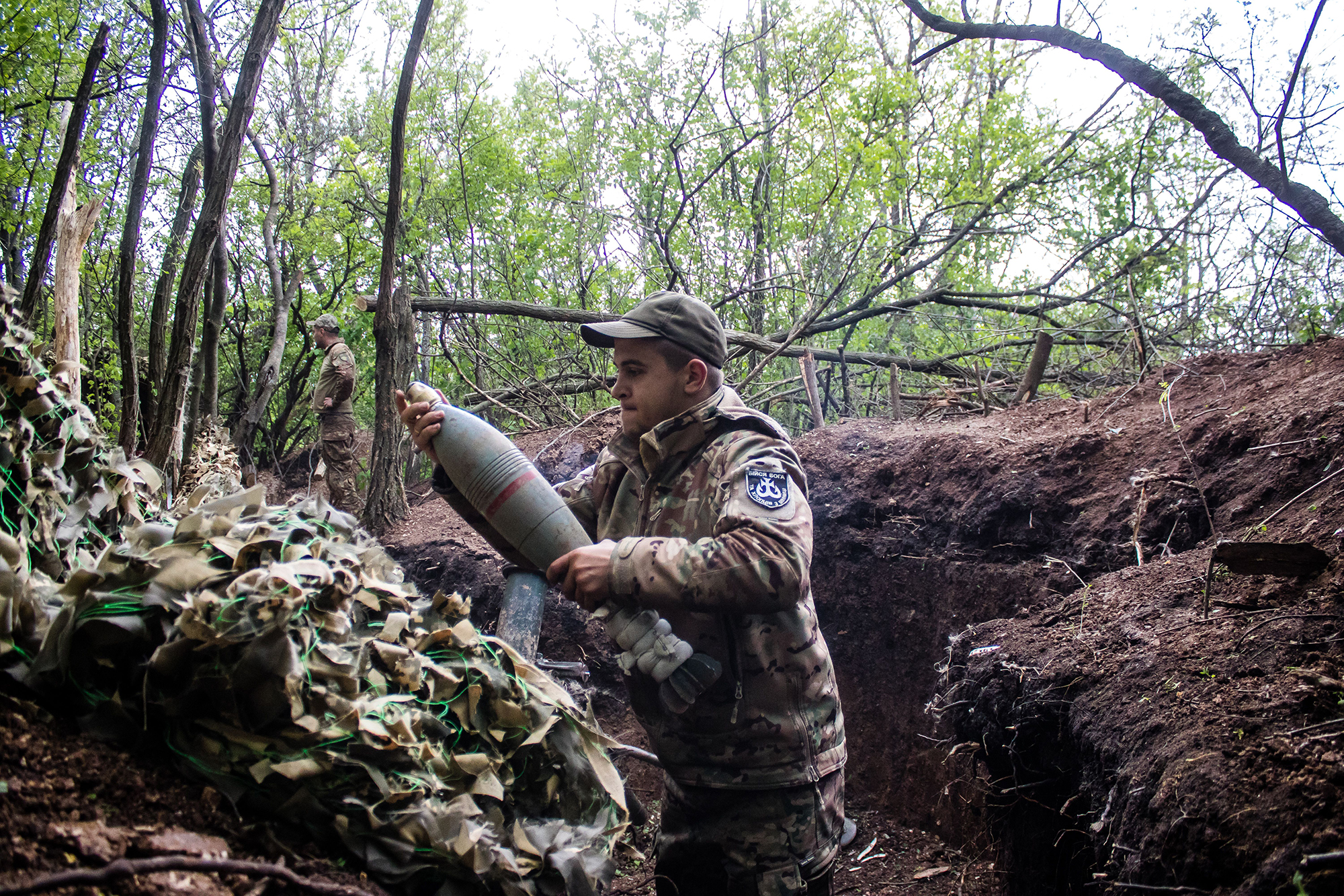 A Ukrainian soldier from the 28th Artillery Battalion fires a 120mm mortar at a Russian target in the forest near Bakhmut, Ukraine, on May 11. 