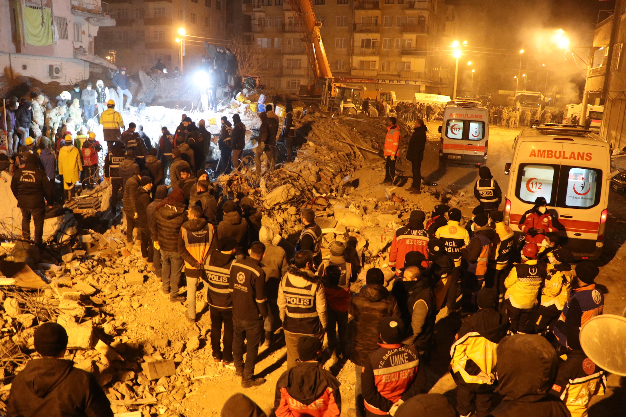 Search and rescue teams work to rescue a woman from under the rubble of a collapsed building in Diyarbakir, Turkey, on Thursday morning.