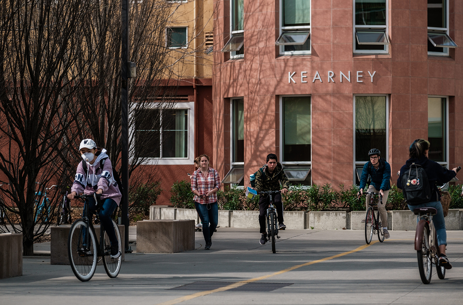 Students cycle past Kearney Hall on the campus of UC Davis on February 28 in Davis, California.
