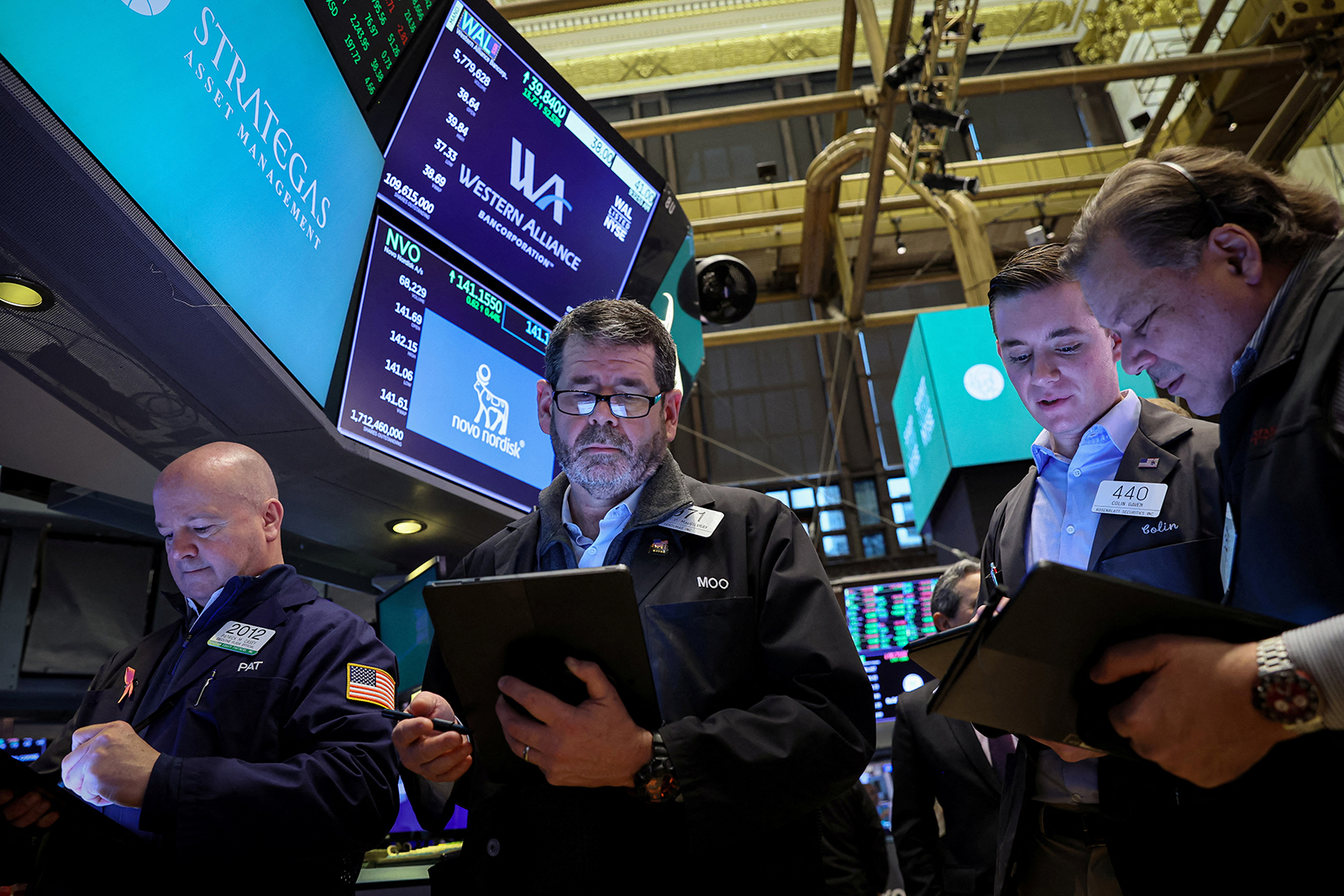 Traders work on the floor of the New York Stock Exchange today in New York City.