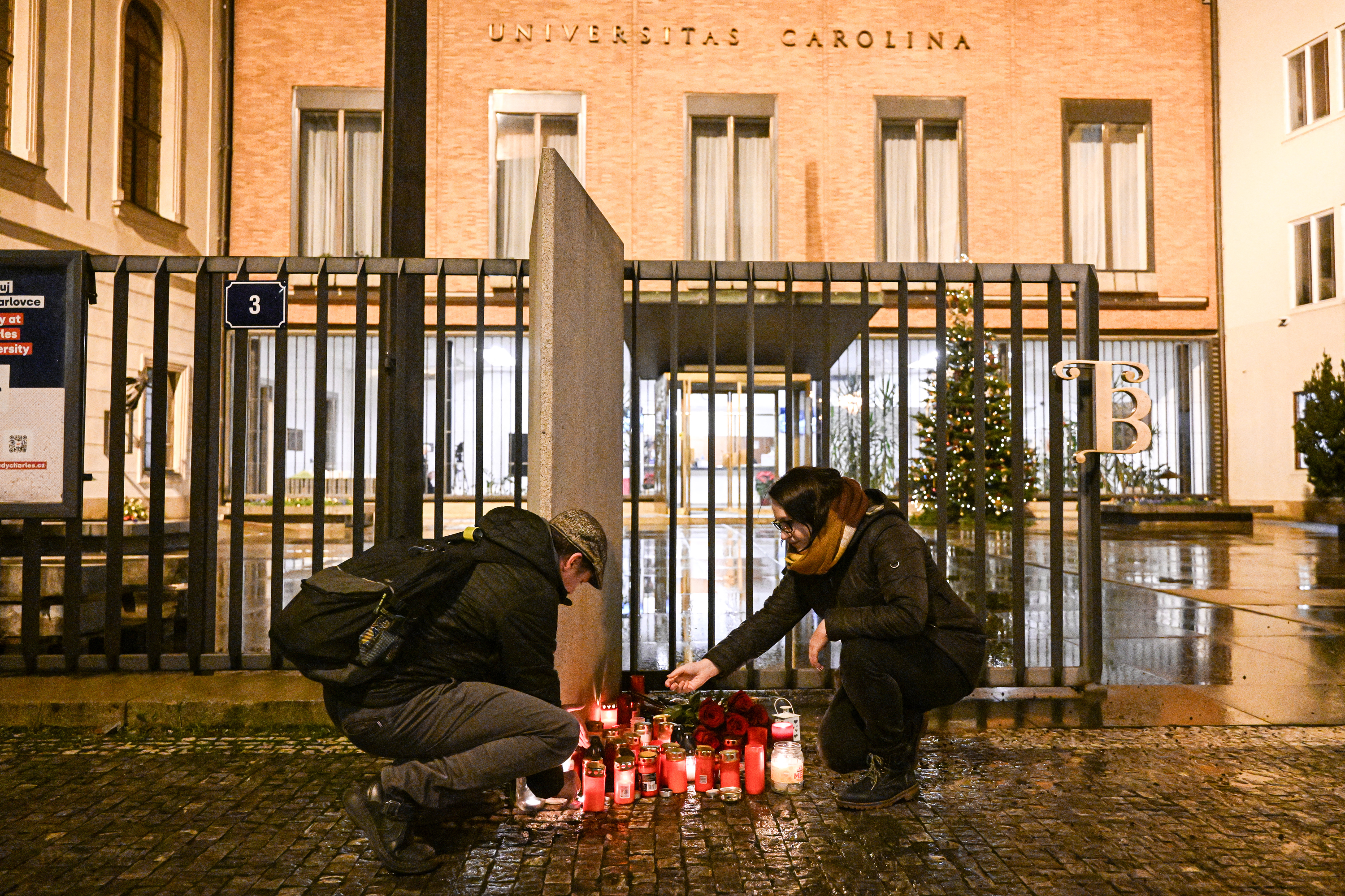 People light candles for the shooting victims at the Charles University main office in central Prague, on December 21.