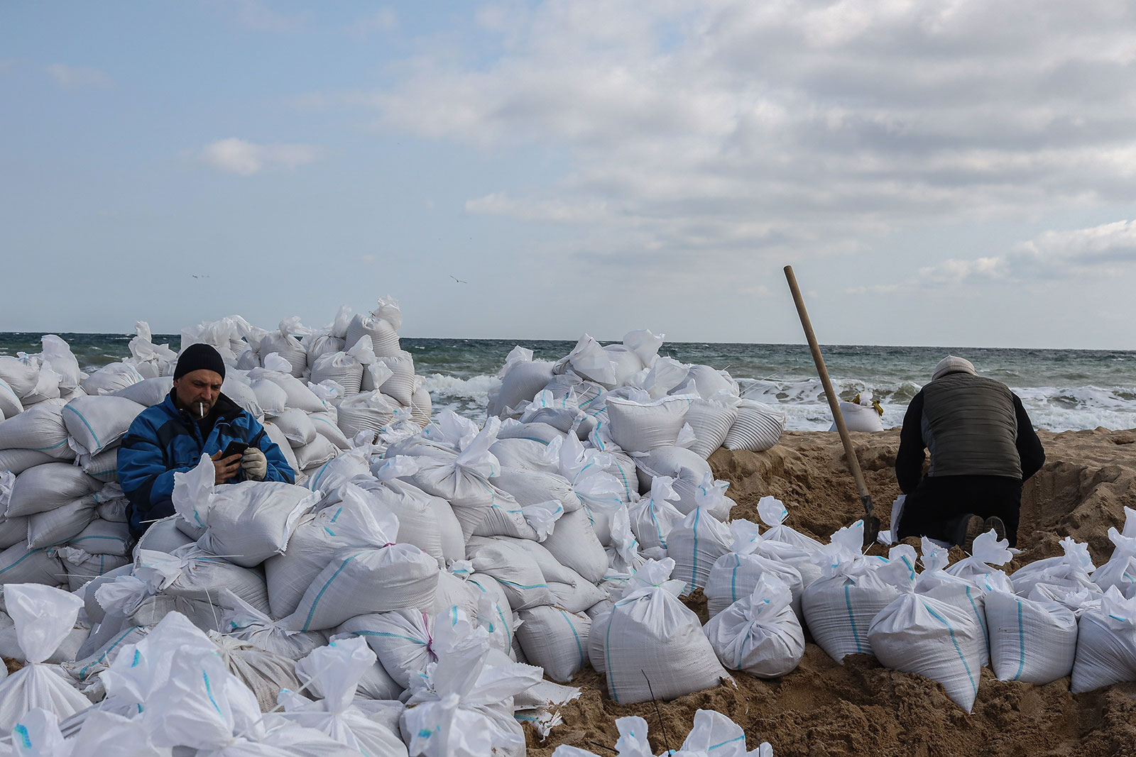 Volunteers fill sand bags at a beach in Odesa, Ukraine, on March 16.