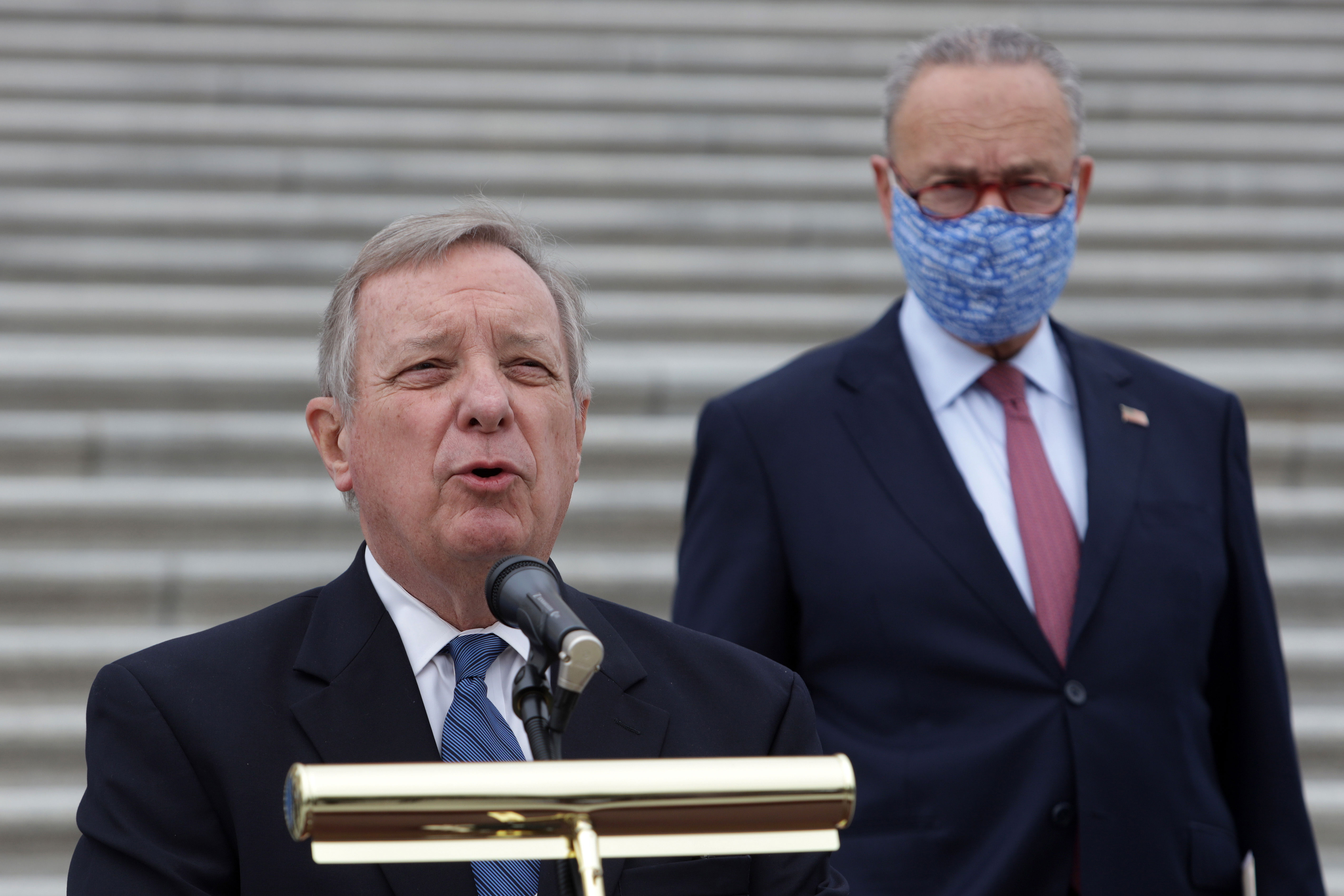 Sen. Dick Durbin, foreground, and Sen. Chuck Schumer attend a news conference in front of the Capitol on October 22.