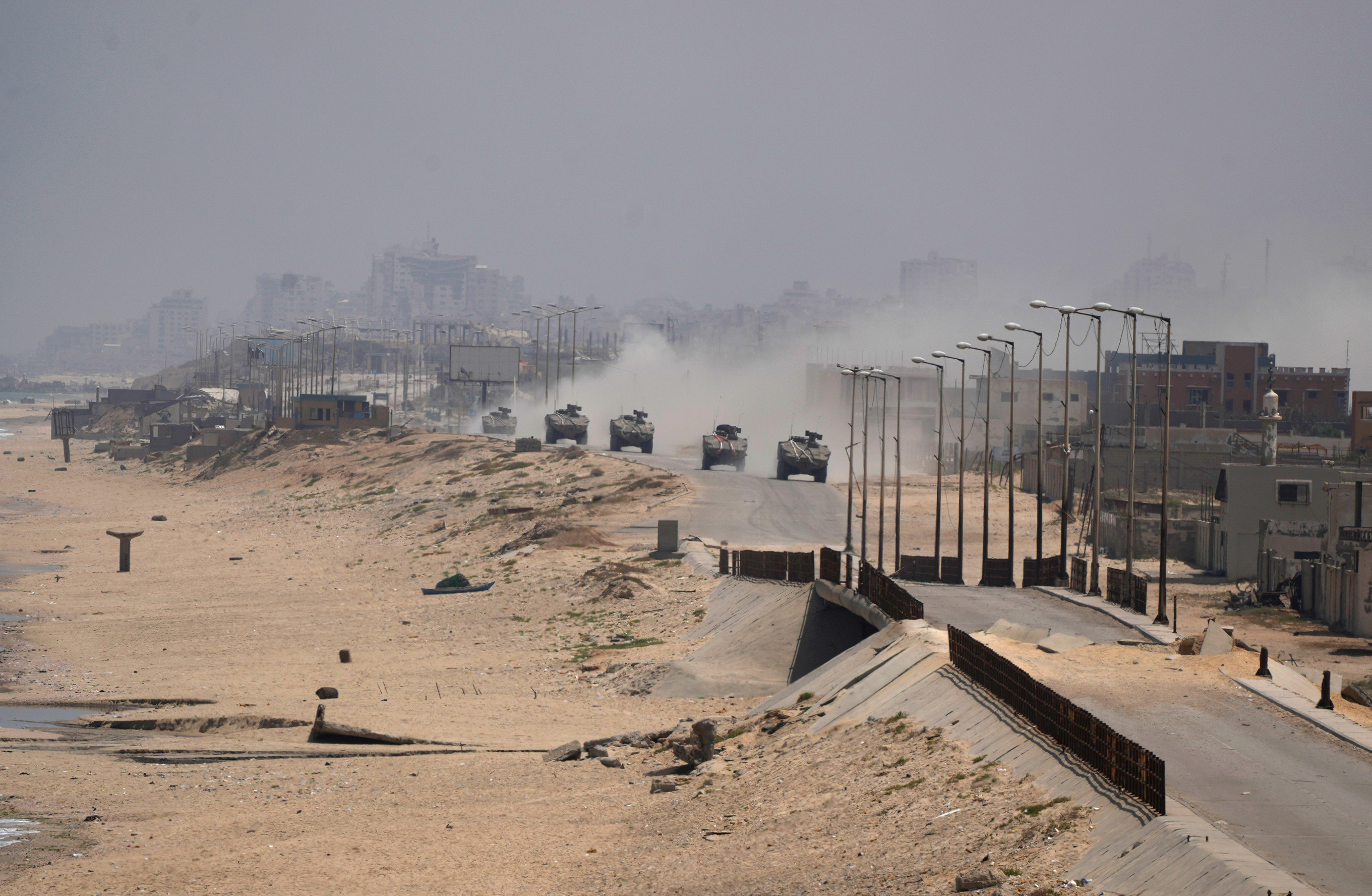 Israeli armored vehicles drive through Deir al-Balah, Gaza, on June 8. 