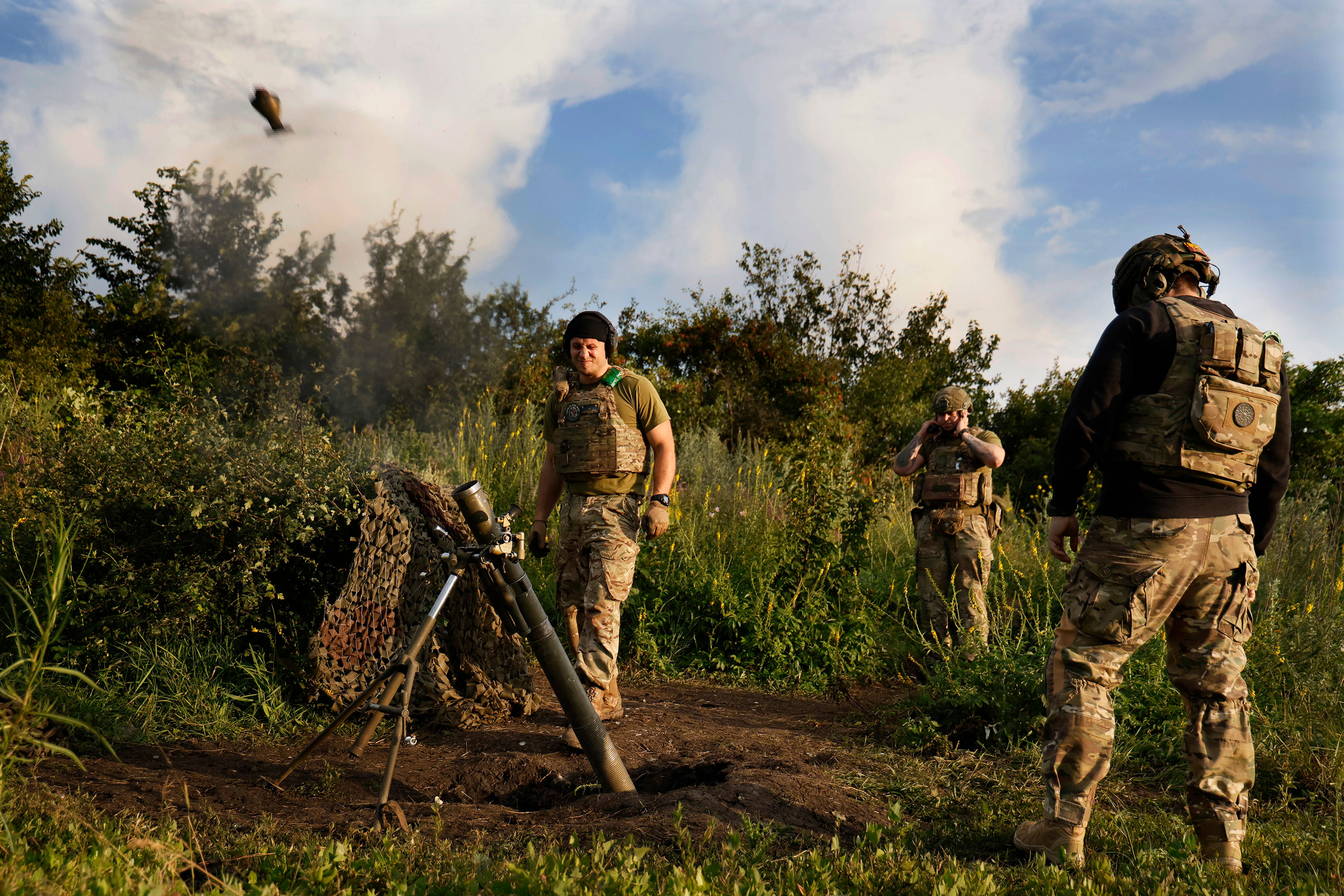 Ukrainian servicemen fire a 82mm mortar towards Russian positions at the frontline near Bakhmut on June 30. 