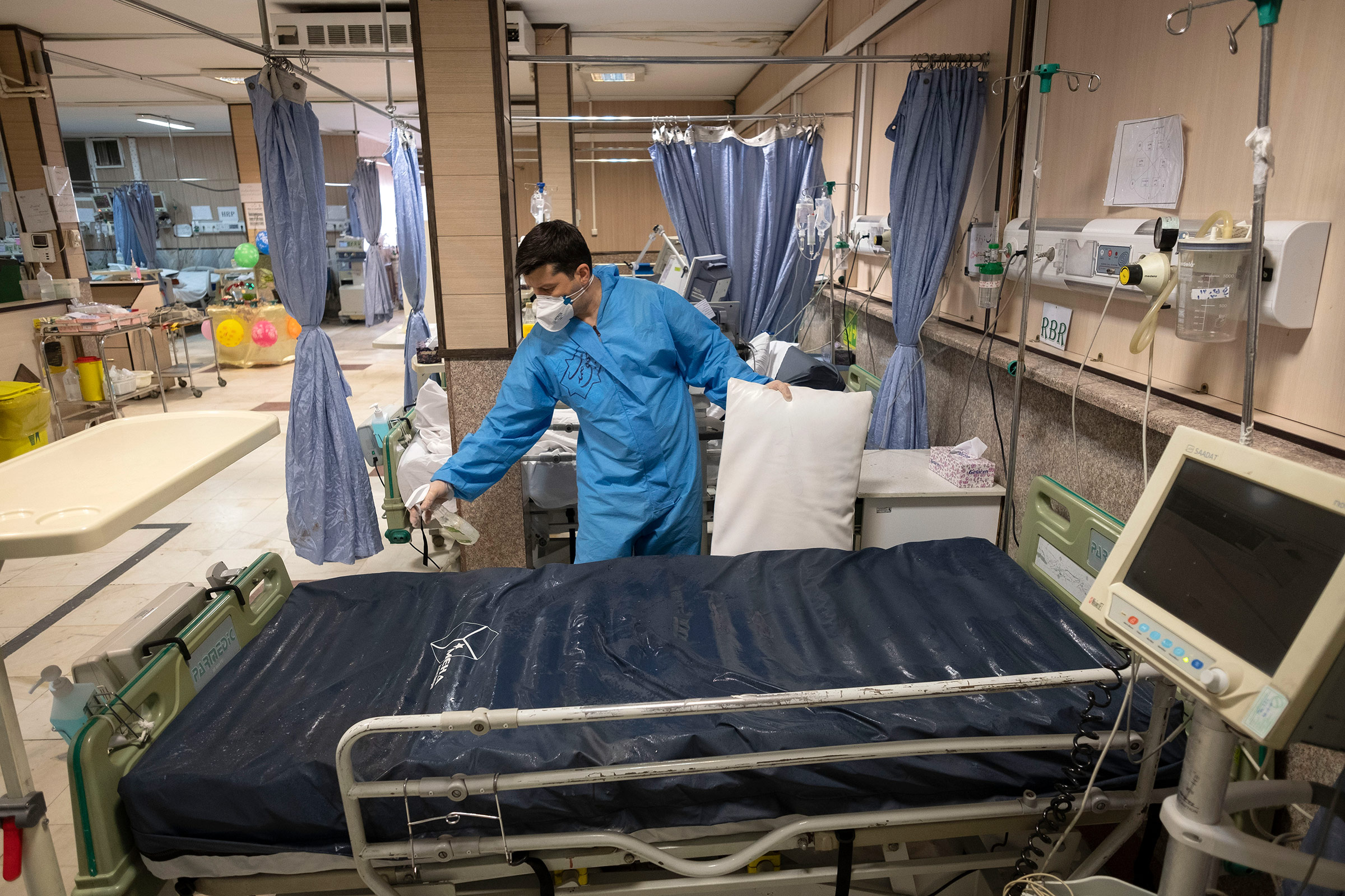 A health assistant disinfects a bed in Firoozabadi hospital's Covid-19 ward in Tehran, Iran, on March 20. 