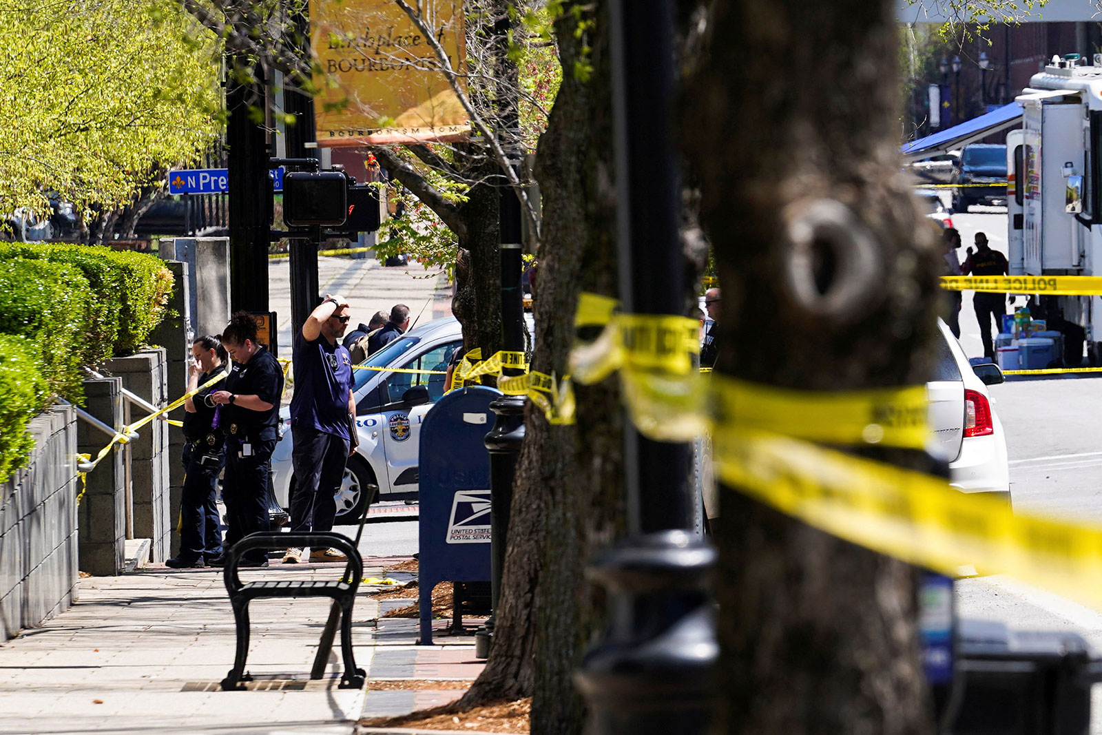 Police deploy at the scene of a shooting in downtown Louisville on Monday.