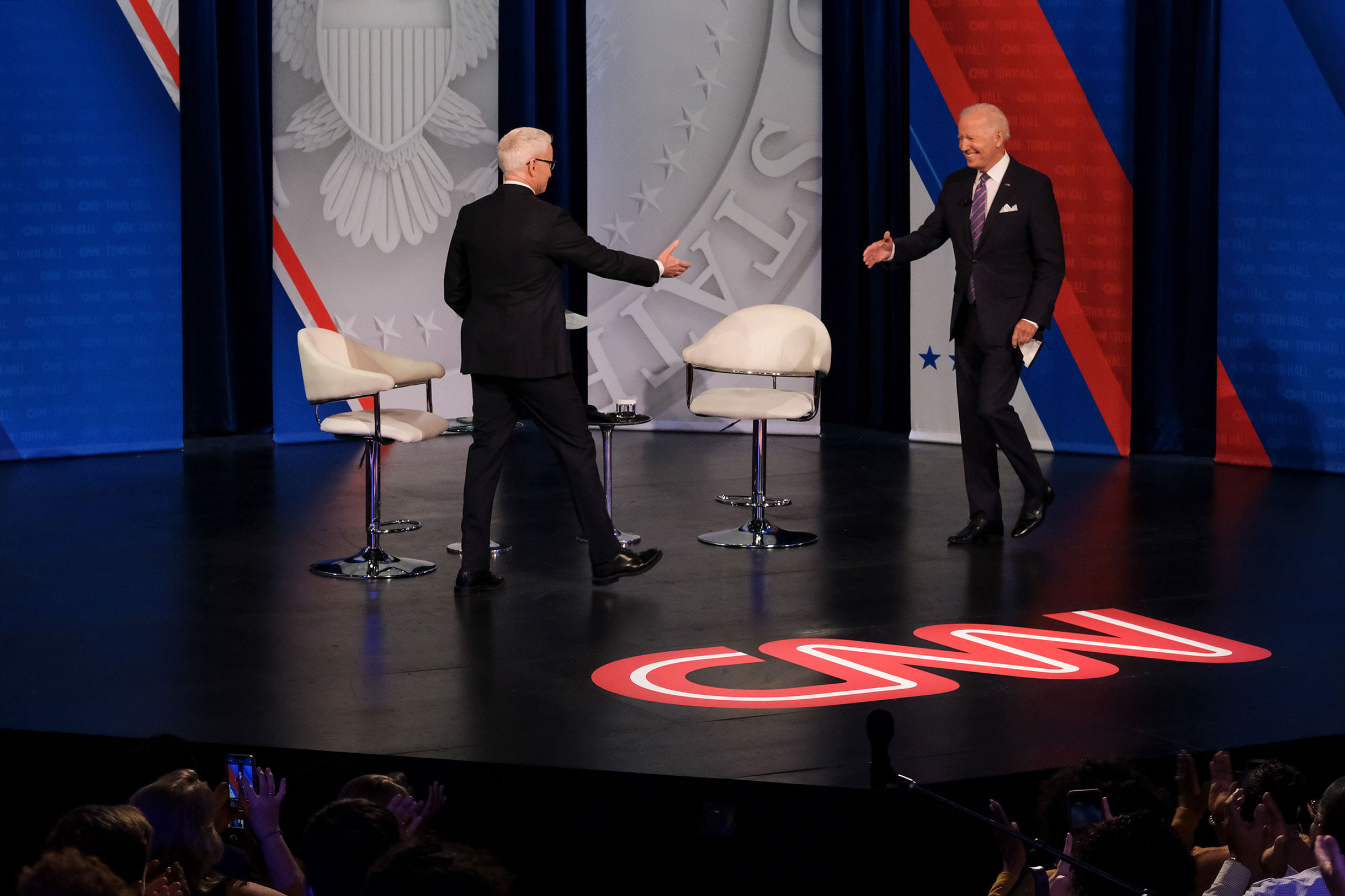 President Joe Biden goes to shake hands with CNN anchor and host Anderson Cooper at CNN's Presidential Town Hall in Baltimore, Maryland, on October 21.