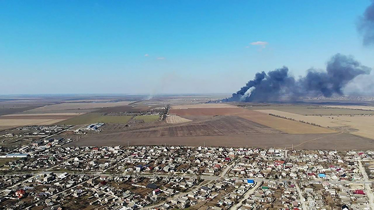 A large plume of smoke rises from the airport.