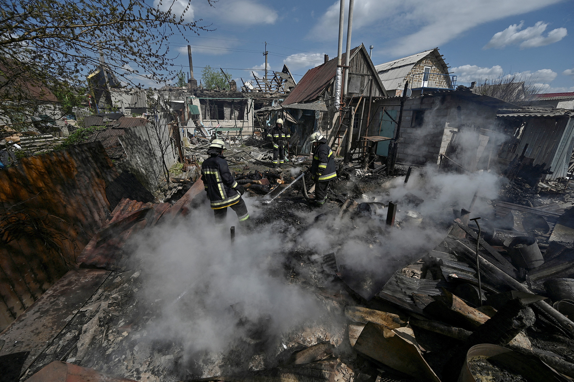 Firefighters work at a site of a residential house destroyed by a Russian military strike in the village of Malokaterynivka, Zaporizhzhia region, Ukraine, on May 11.
