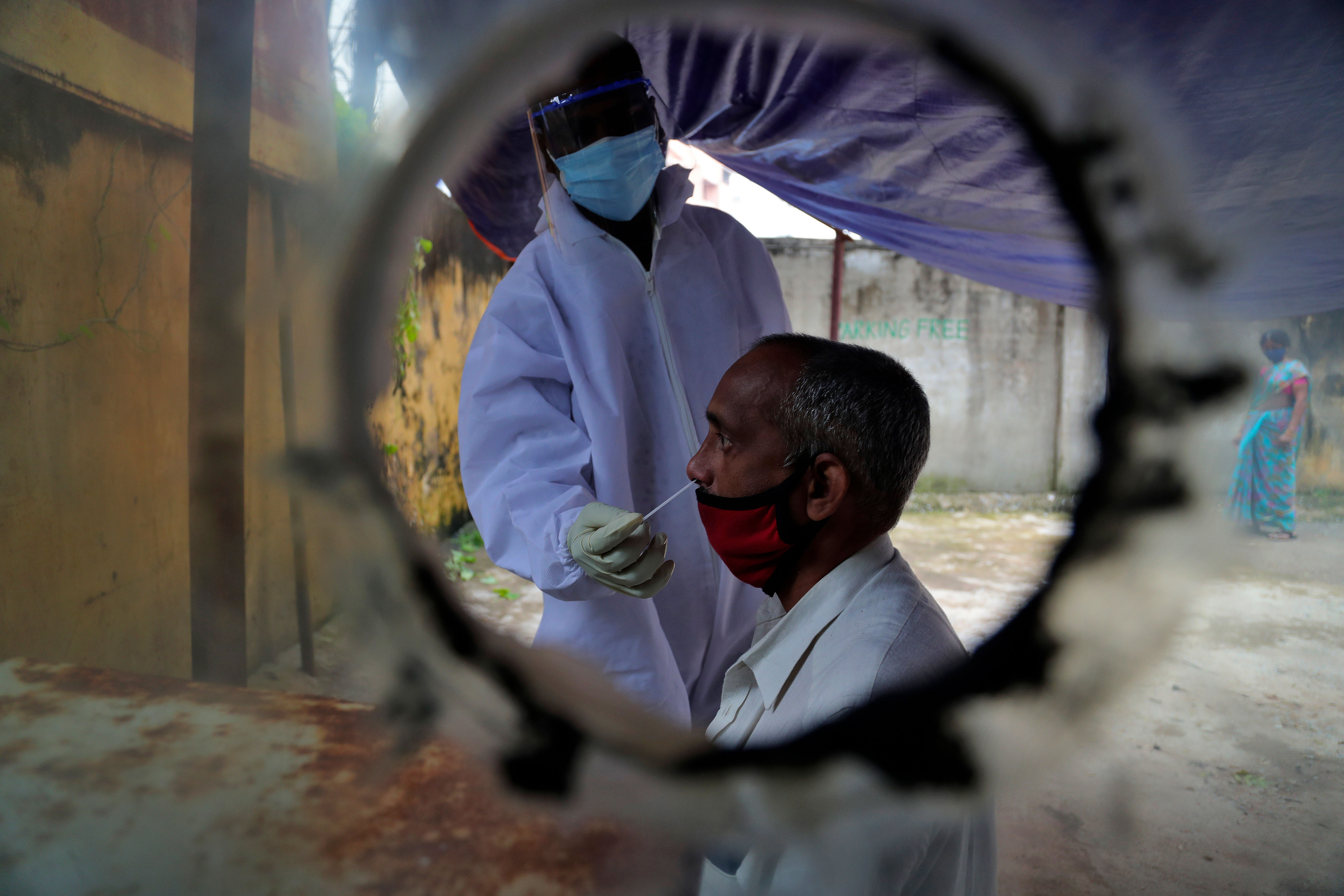 A health worker collects a nasal swab to test for Covid-19 in Hyderabad, India, on October 20.