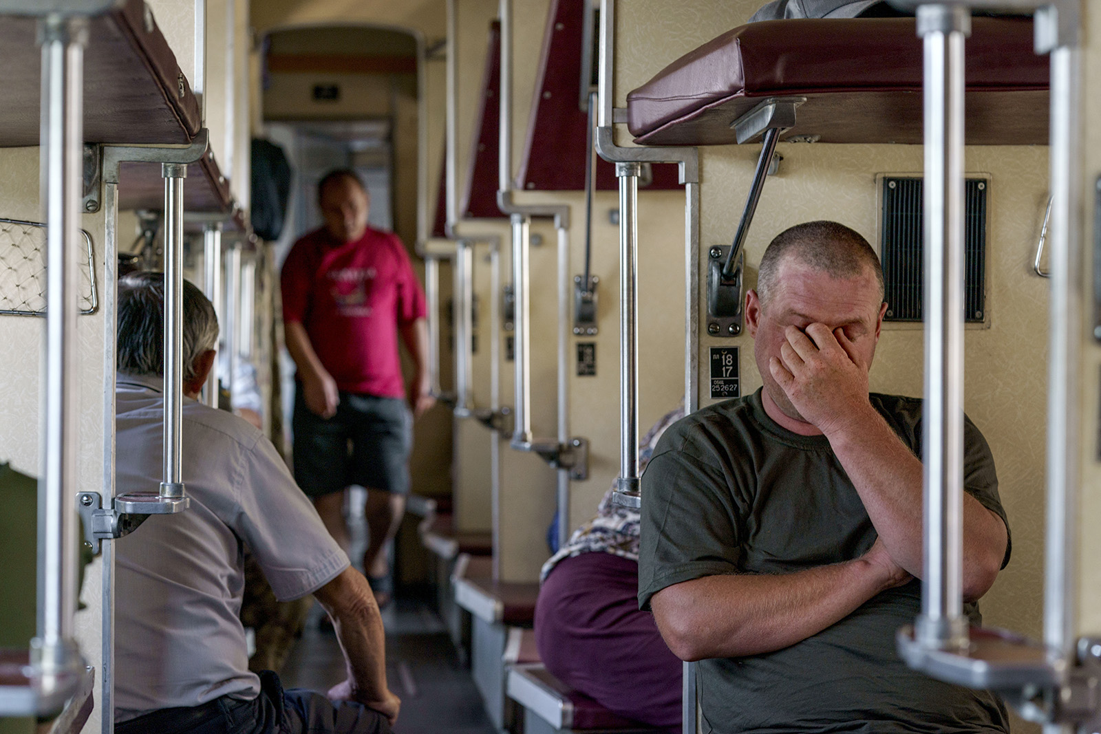 A passenger sits on an evacuation train waiting to depart from Pokrovsk in eastern Ukraine, heading west to a safer part of the country, on August 2.