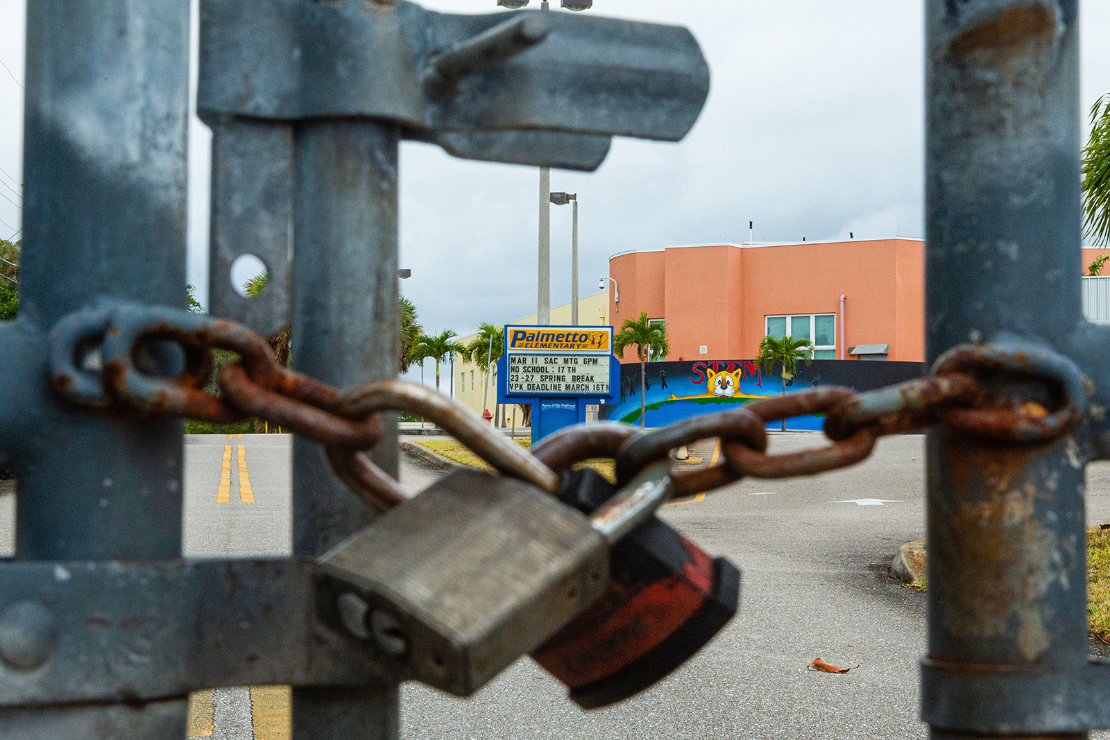 The exterior gates of Palmetto Elementary School in West Palm Beach are locked shut following the school's closure due to the coronavirus pandemic.