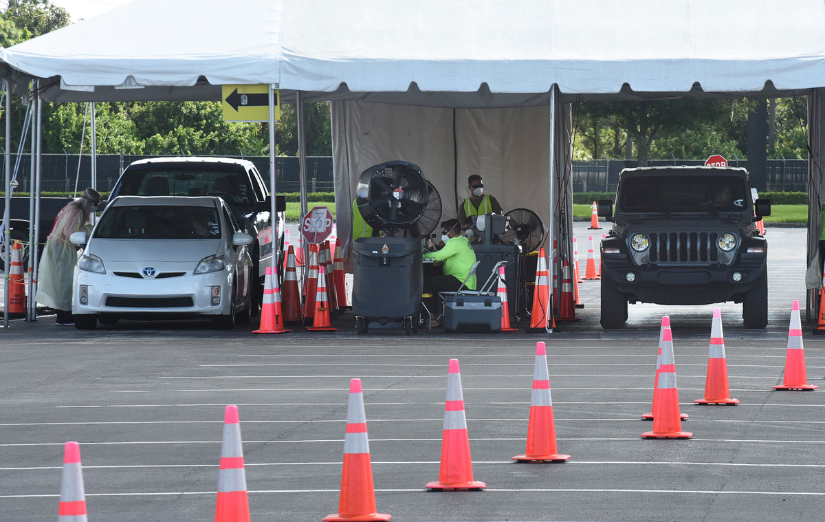 People arrive at a drive-through COVID-19 testing site at Eastern Florida State College on October 9 in Palm Bay, Florida.