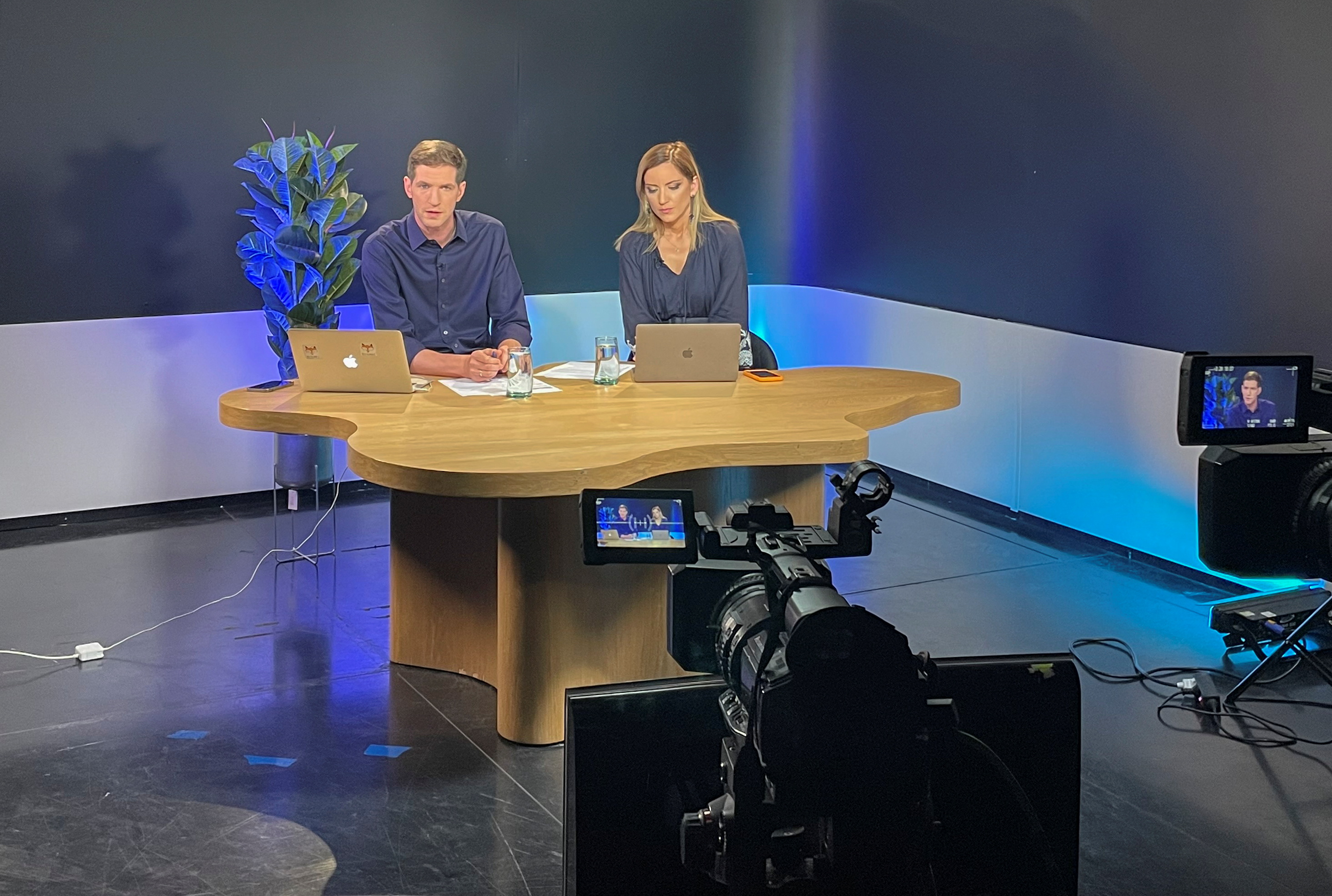 TV Rain (Dozhd) editor-in-chief Tikhon Dzyadko and news anchor Ekaterina Kotrikadze work in a studio at the start of live newscast in Tbilisi, Georgia, in June 2022.