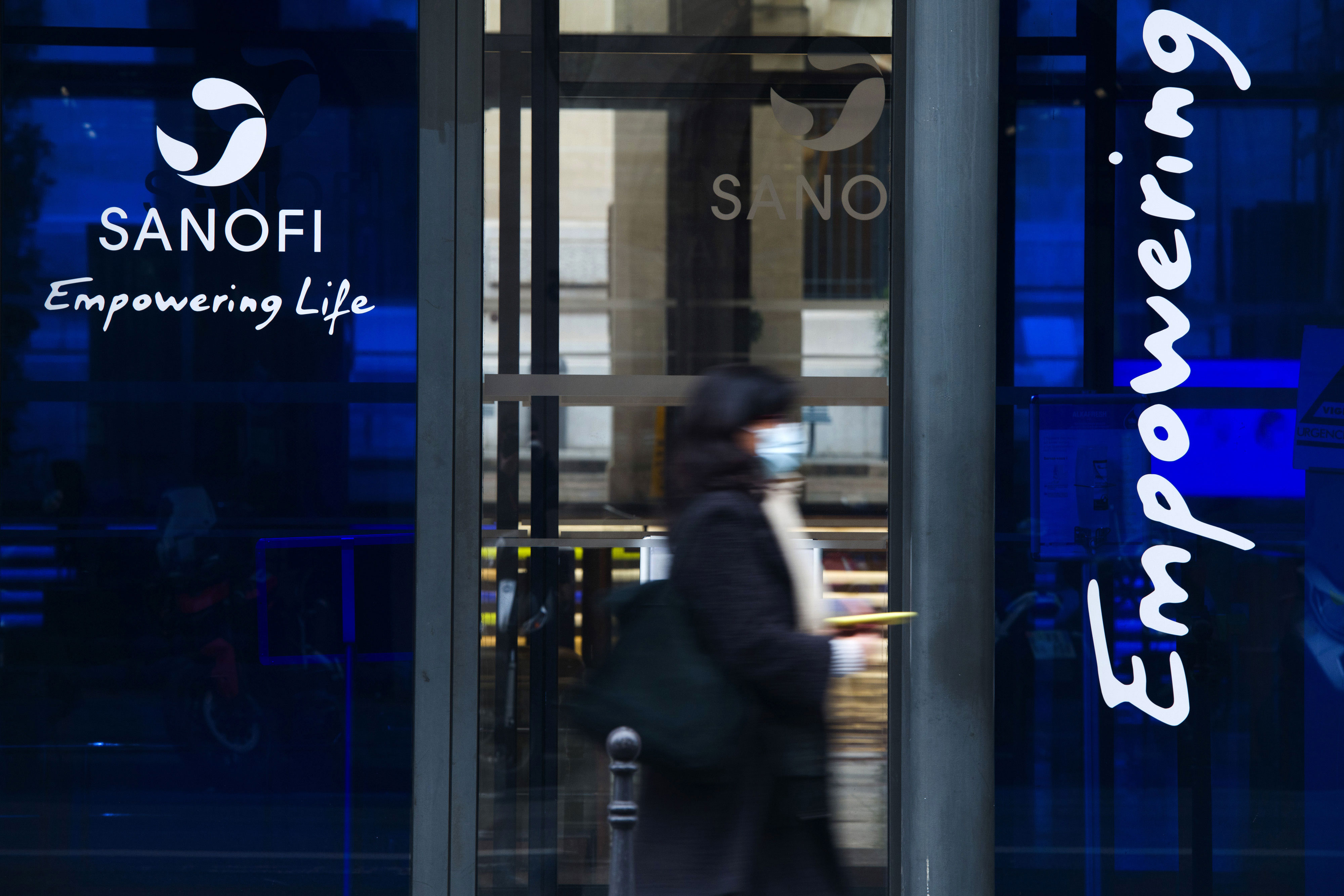 A person passes the Sanofi office in Paris on January 28.