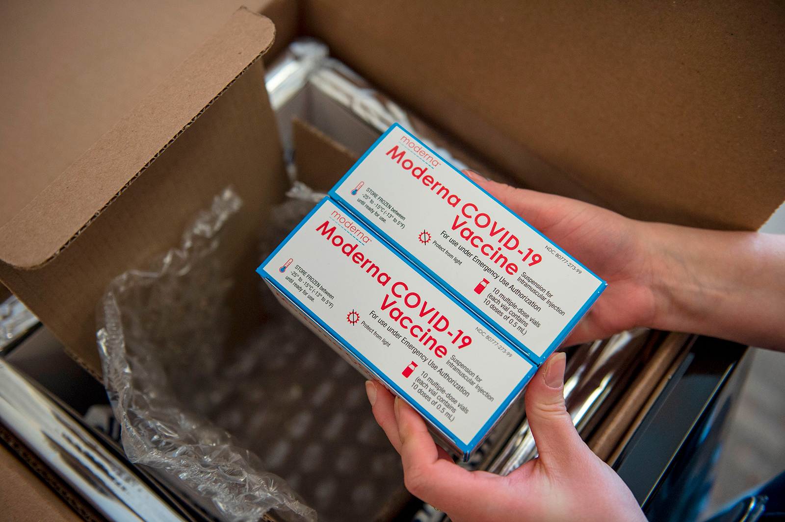 A nurse unpacks a box of Moderna Covid-19 vaccines at the East Boston Neighborhood Health Center (EBNHC) in Boston, Massachusetts, on December 24, 2020. 