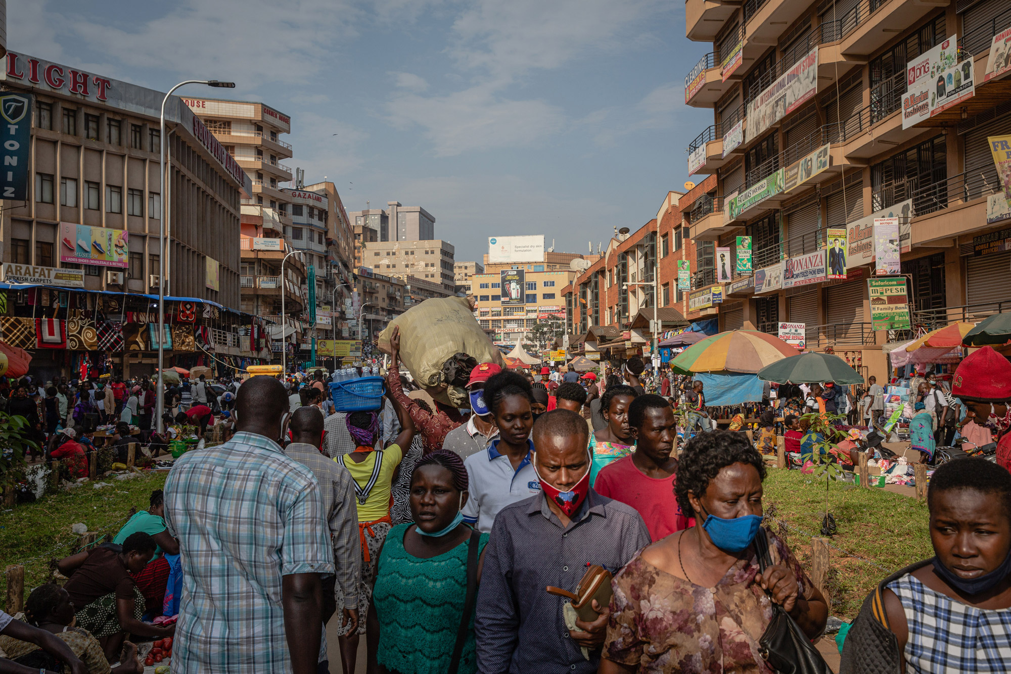 People make their way along a street in downtown Kampala, Uganda, on June 23. 