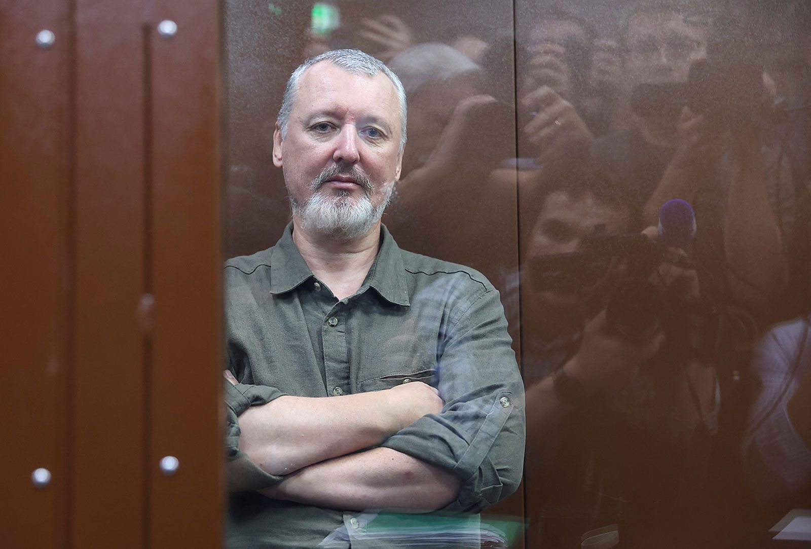 Igor Girkin sits behind a glass wall of an enclosure for defendants before a court hearing in Moscow, Russia, on Friday, July 21.