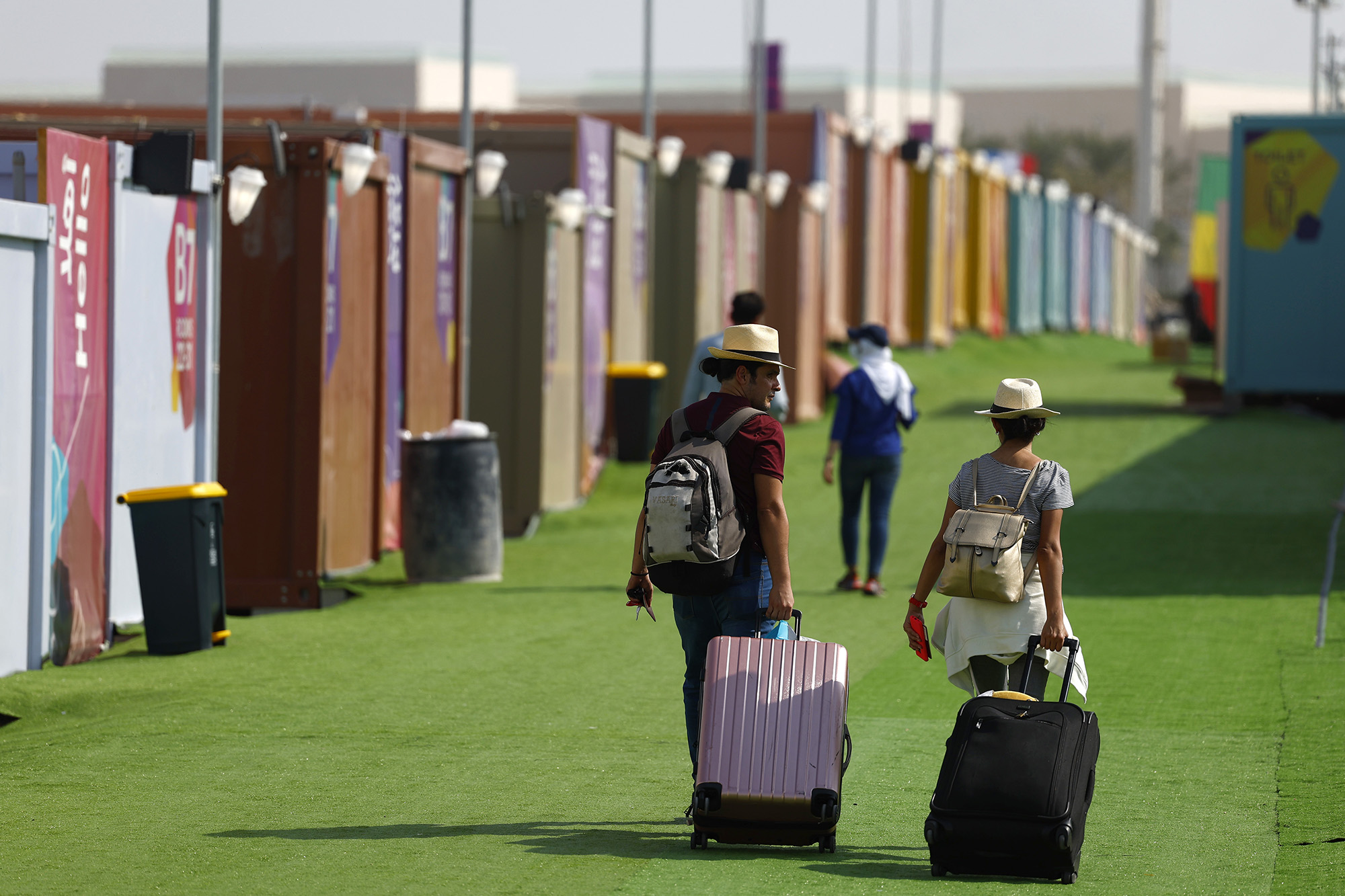 People arrive at a fan village ahead of the FIFA World Cup Qatar 2022 on November 19, in AI-Rayyan, Qatar. 