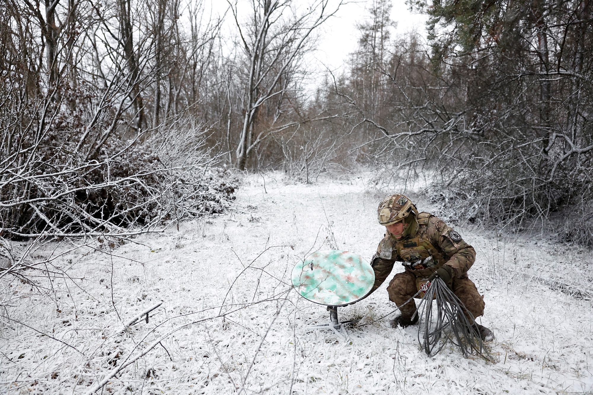 A member of the 80th Separate Air Assault Brigade disconnects their Starlink on the front line in Kreminna, Ukraine, on January 6.