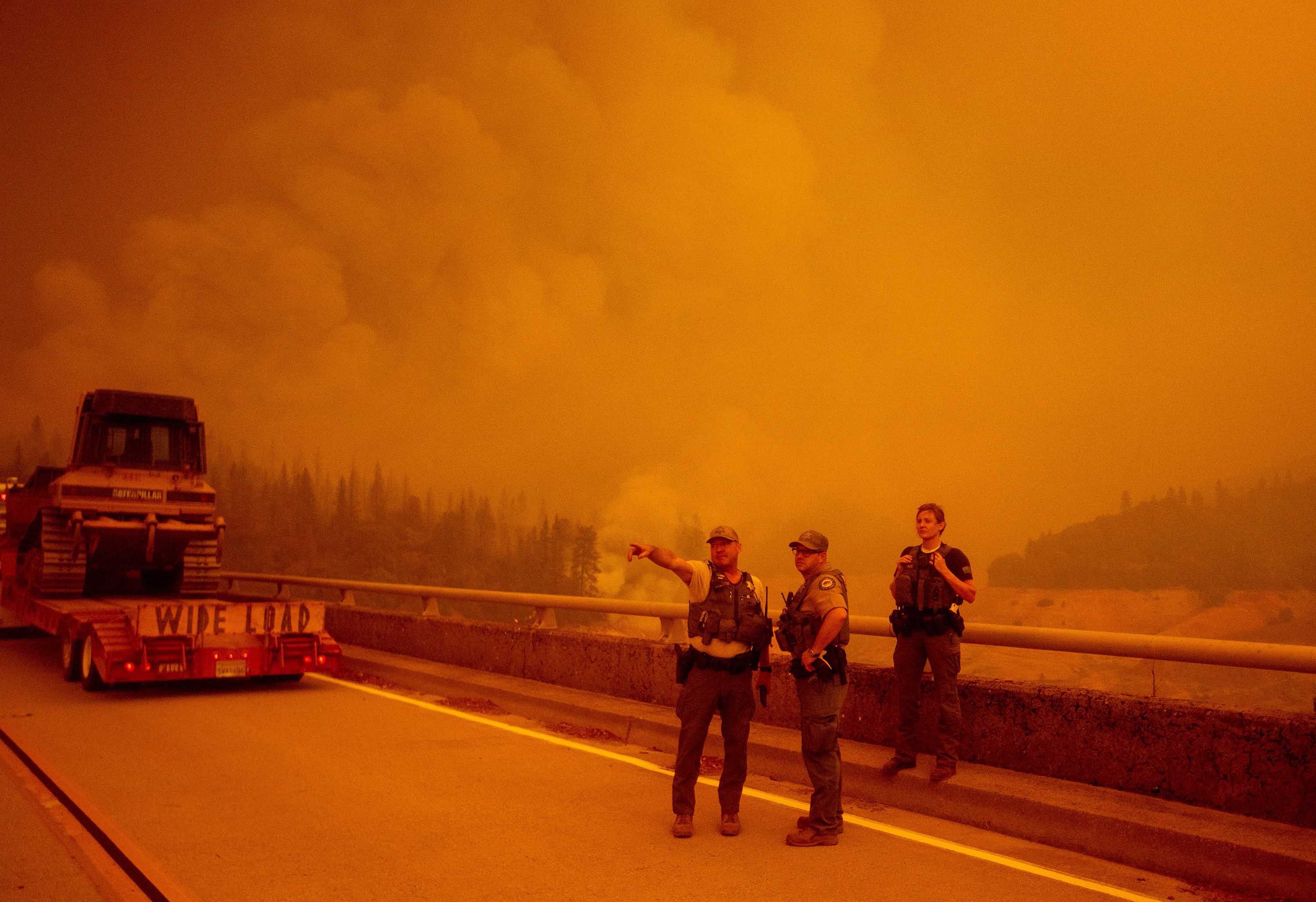 Law enforcement and fire personnel wait to enter an area encroached by fire during the Bear fire, part of the North Lightning Complex fires, in Oroville, California on September 9.