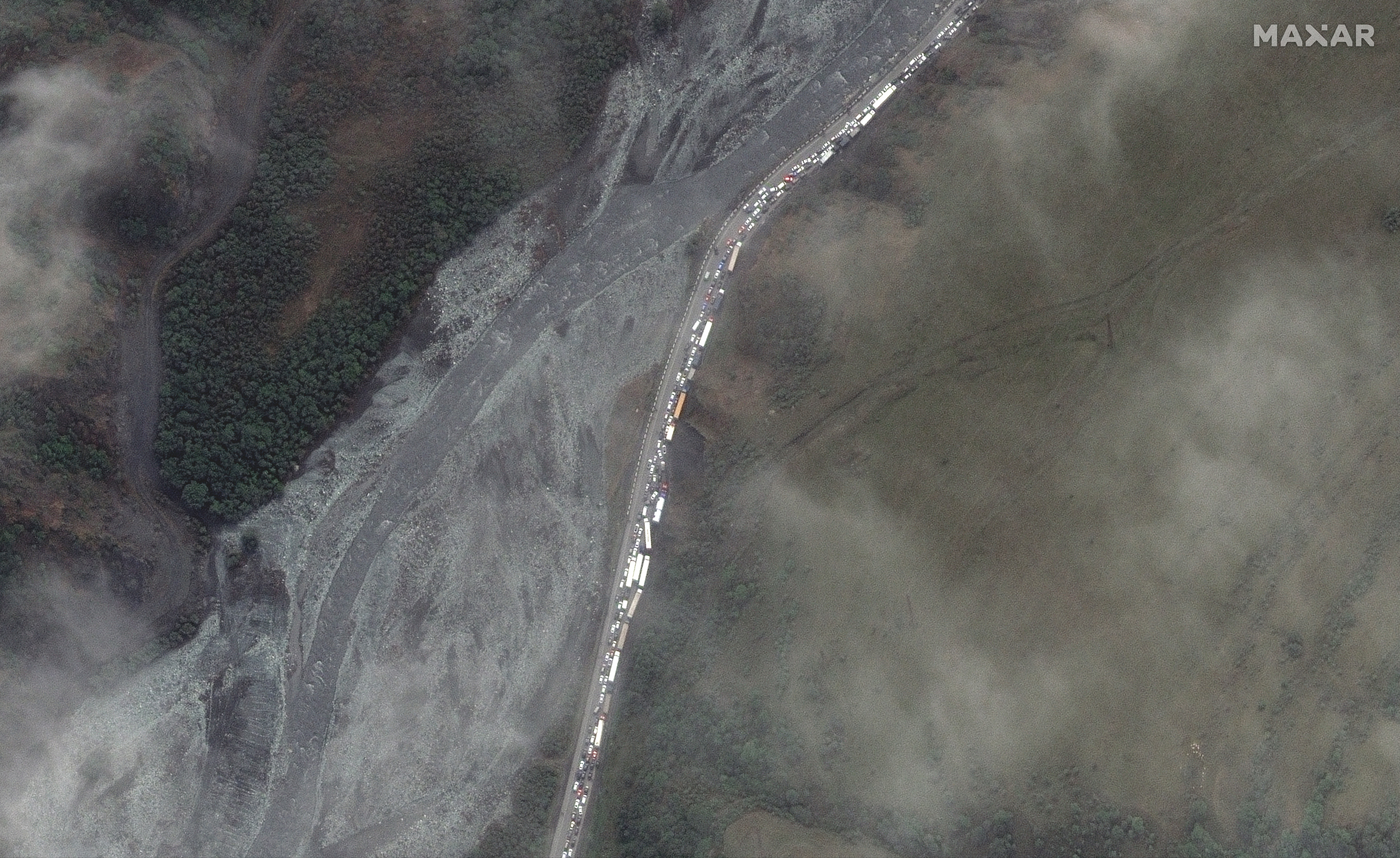 A satellite image shows traffic queuing approximately 16 kilometers (nearly 10 miles) north of the Georgian border crossing. 