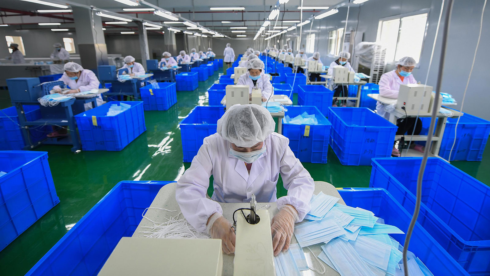 Employees produce face masks on a production line at a workshop of Hangzhou Yijia Textile Co., Ltd in Hangzhou, Zhejiang Province of China on April 23. 