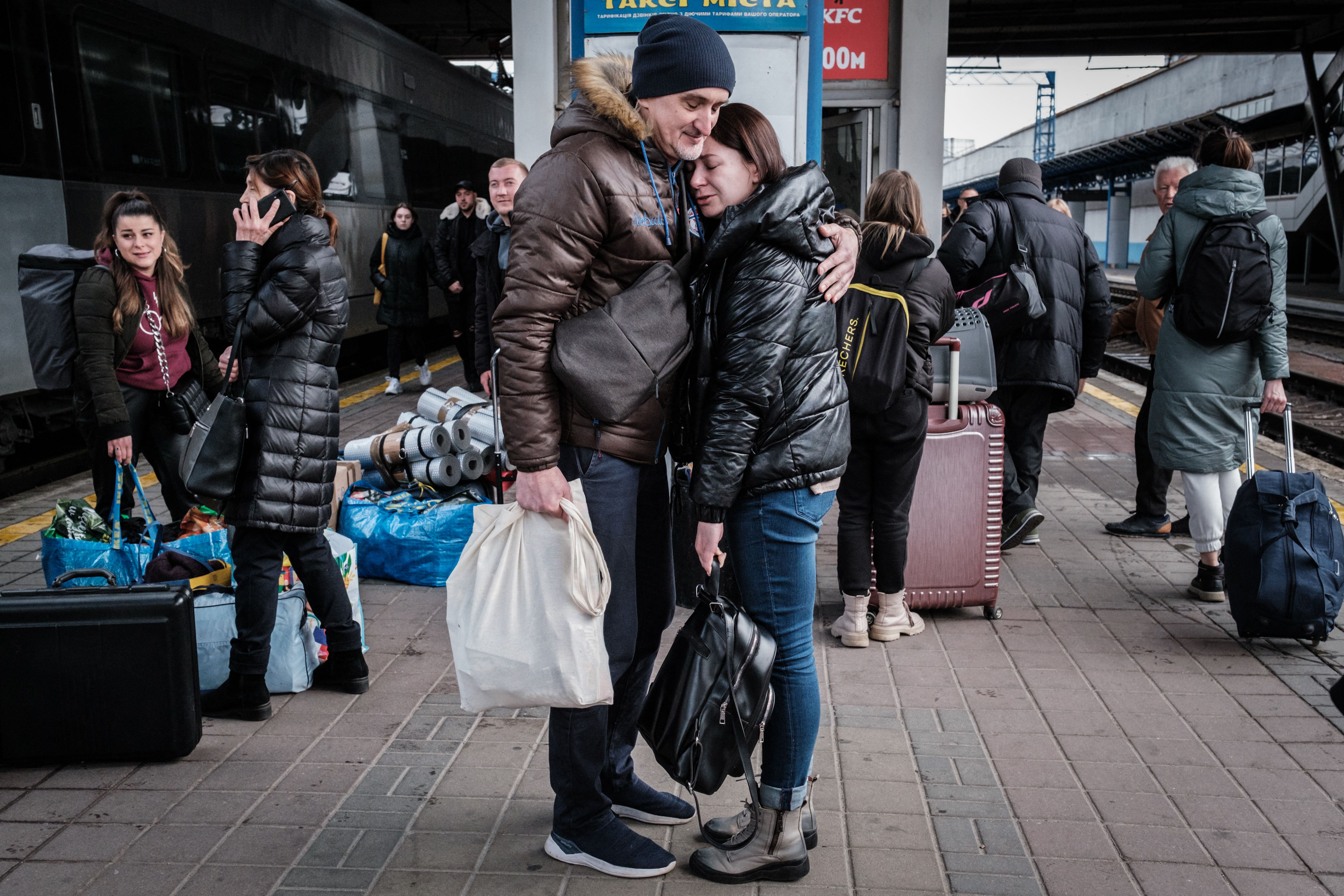 Ihor, center left, welcomes Lyudmila who has returned from neighboring Poland as they stand on a platform at the Kyiv-Pasazhyrskyi train station, in the Ukrainian capital Kyiv on April 17.