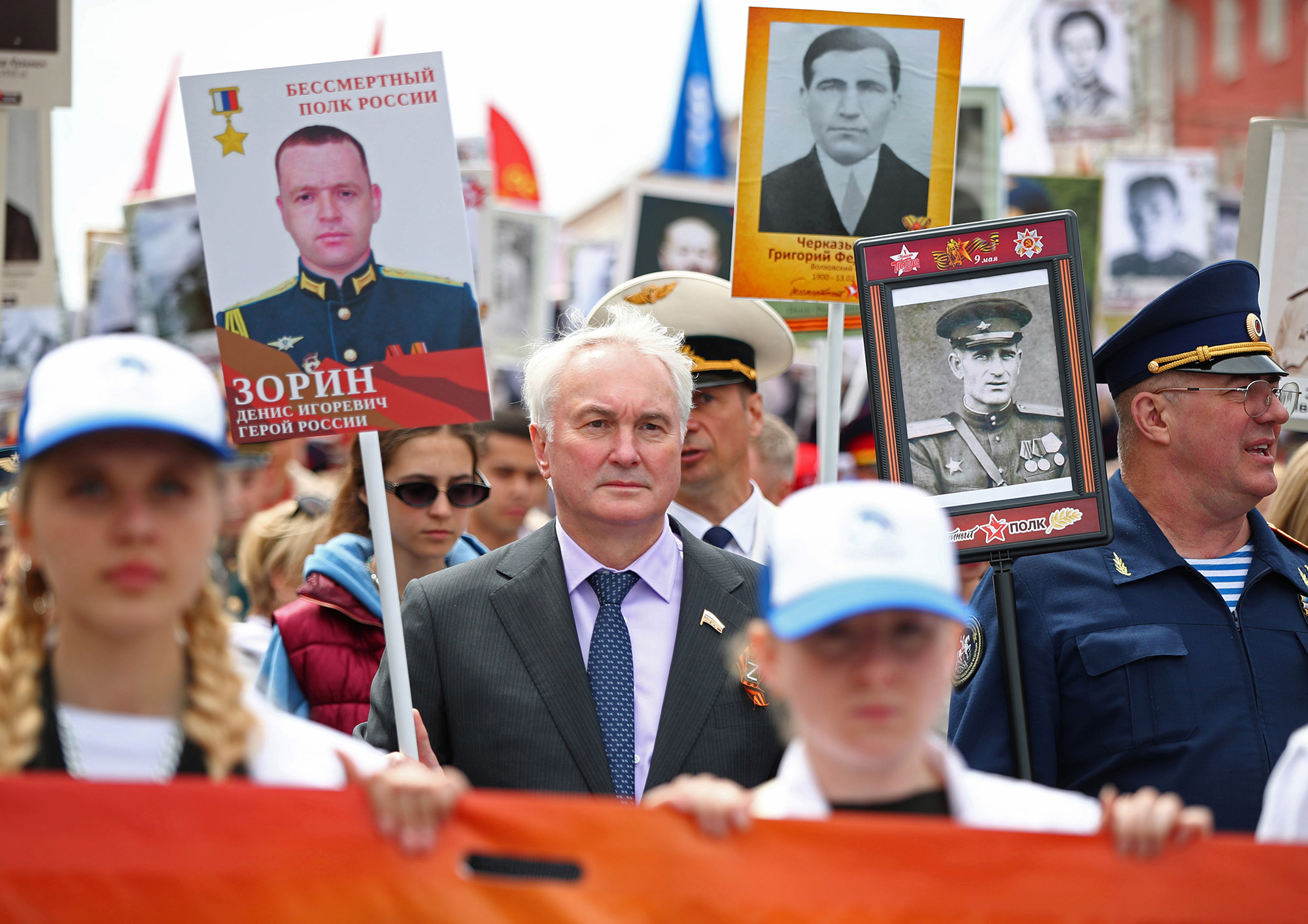 Chairman of the Committee on Defence of Russia's State Duma Andrei Kartapolov, center, takes part in the Immortal Regiment march on Victory Day in Volgograd, Russia, on May 9.