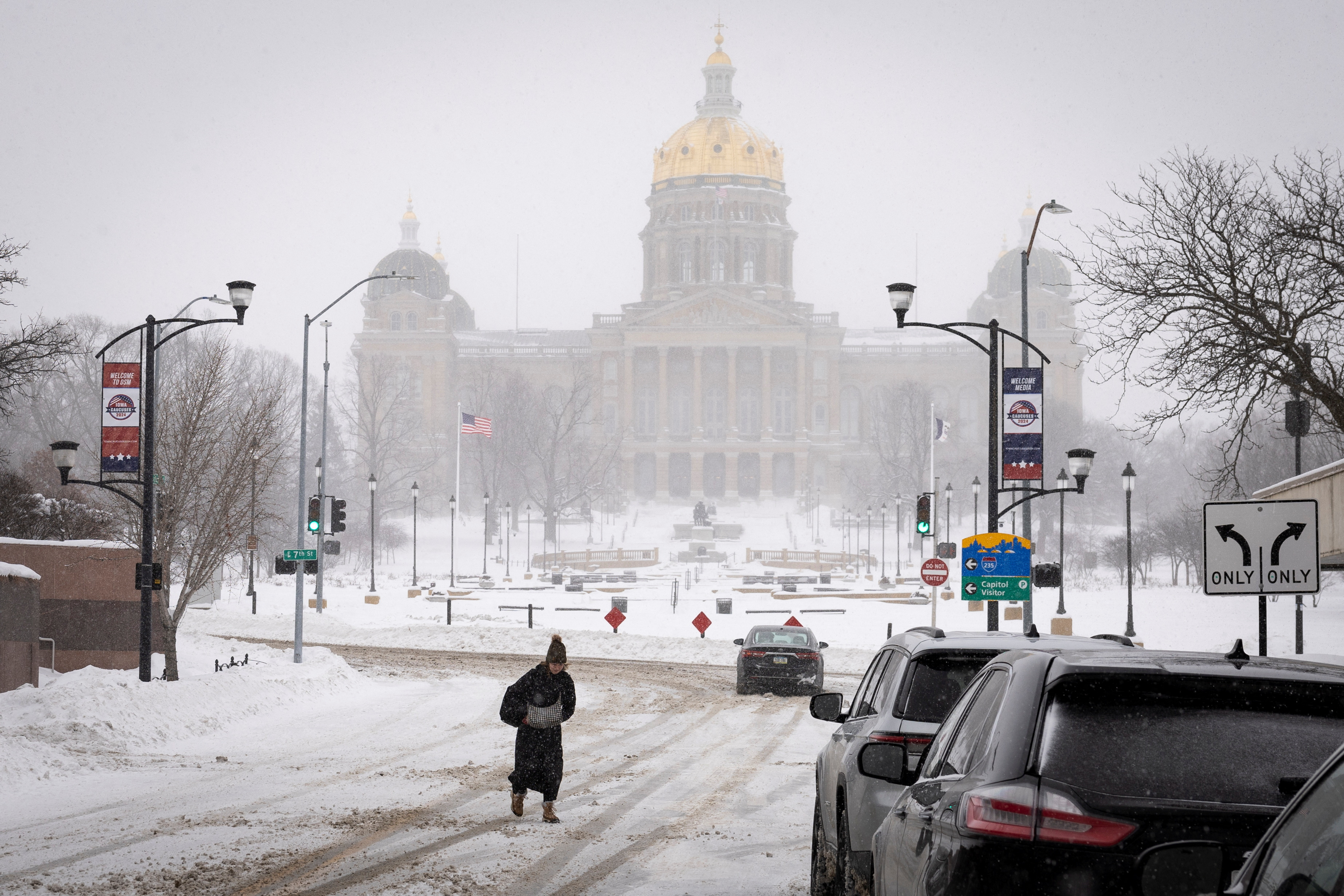 A person walks near the Iowa State Capitol after a blizzard left several inches of snow in Des Moines, Iowa, on January 13.