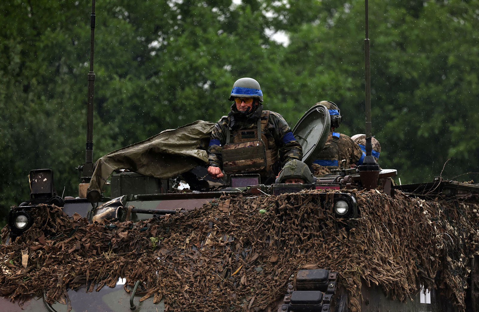 Ukrainian servicemen ride atop an armoured personnel carrier vehicle in the Zaporizhzhya region on Sunday, June 11, 2023. 