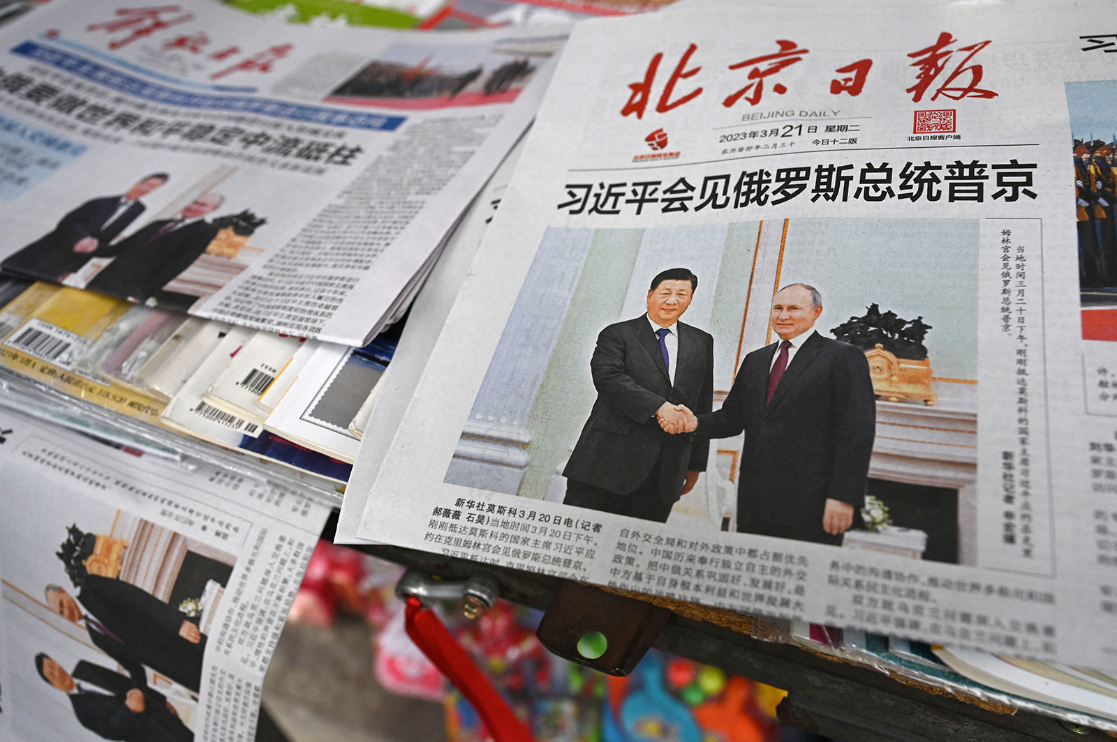 Newspapers featuring a front page photo of Chinese leader Xi Jinping meeting with Russian President Vladimir Putin in Moscow, are displayed at a news stand in Beijing on March 21.