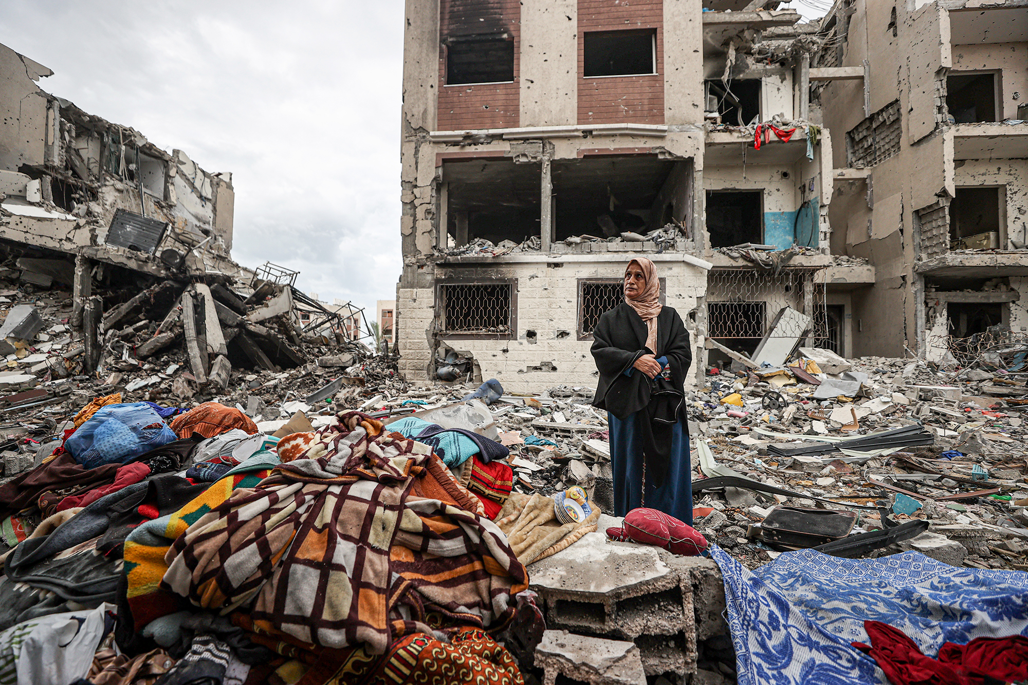 A woman stands among the rubble of residential buildings in Gaza, on November 28. 
