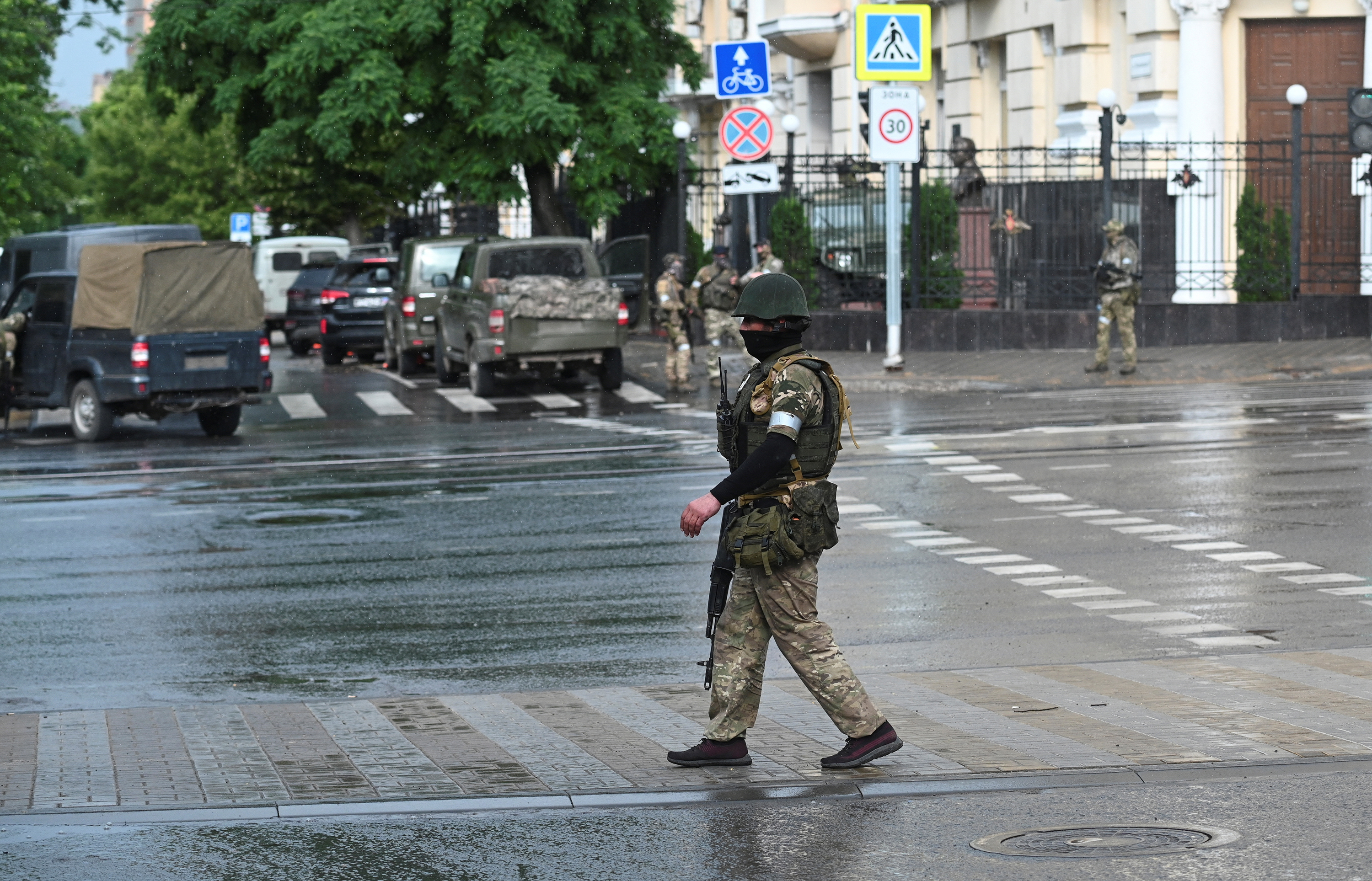 Fighters of Wagner private mercenary group stand guard in a street near the headquarters of the Southern Military District in the city of Rostov-on-Don, Russia, June 24.