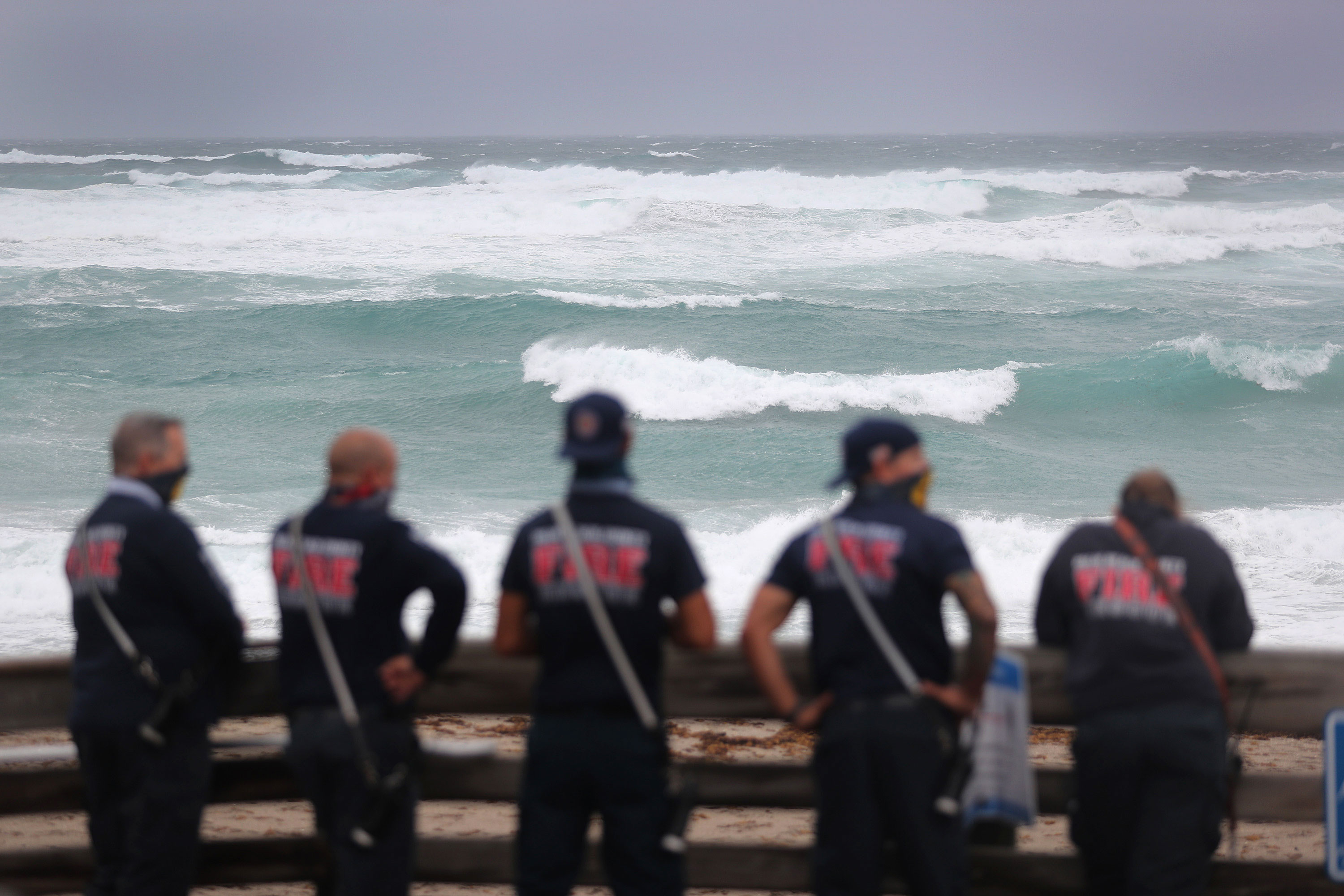 Palm Beach County Fire Rescue look out at the ocean as Tropical Storm Isaias passes through the area on Sunday, August 2 in Juno Beach, Florida. 